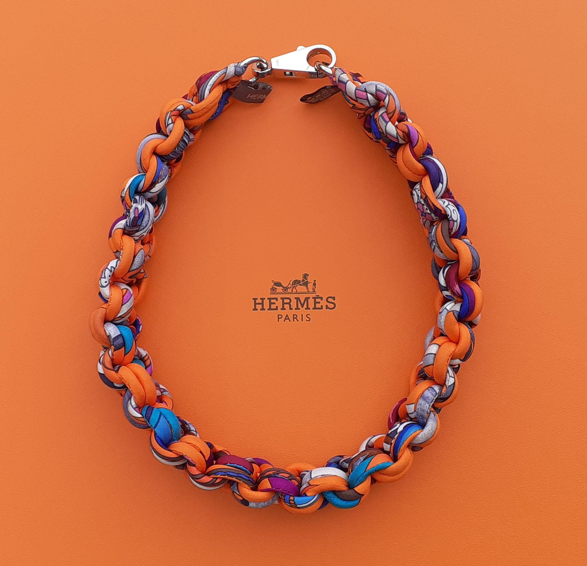 Rare and Beautiful Authentic Hermès Necklace

Pattern: sophisticated braid

Made in France

Made of 100% Silk

Colorways: Orange, Purple, Blue, Turquoise, Grey

Carabiner clasp in siler tone metal

