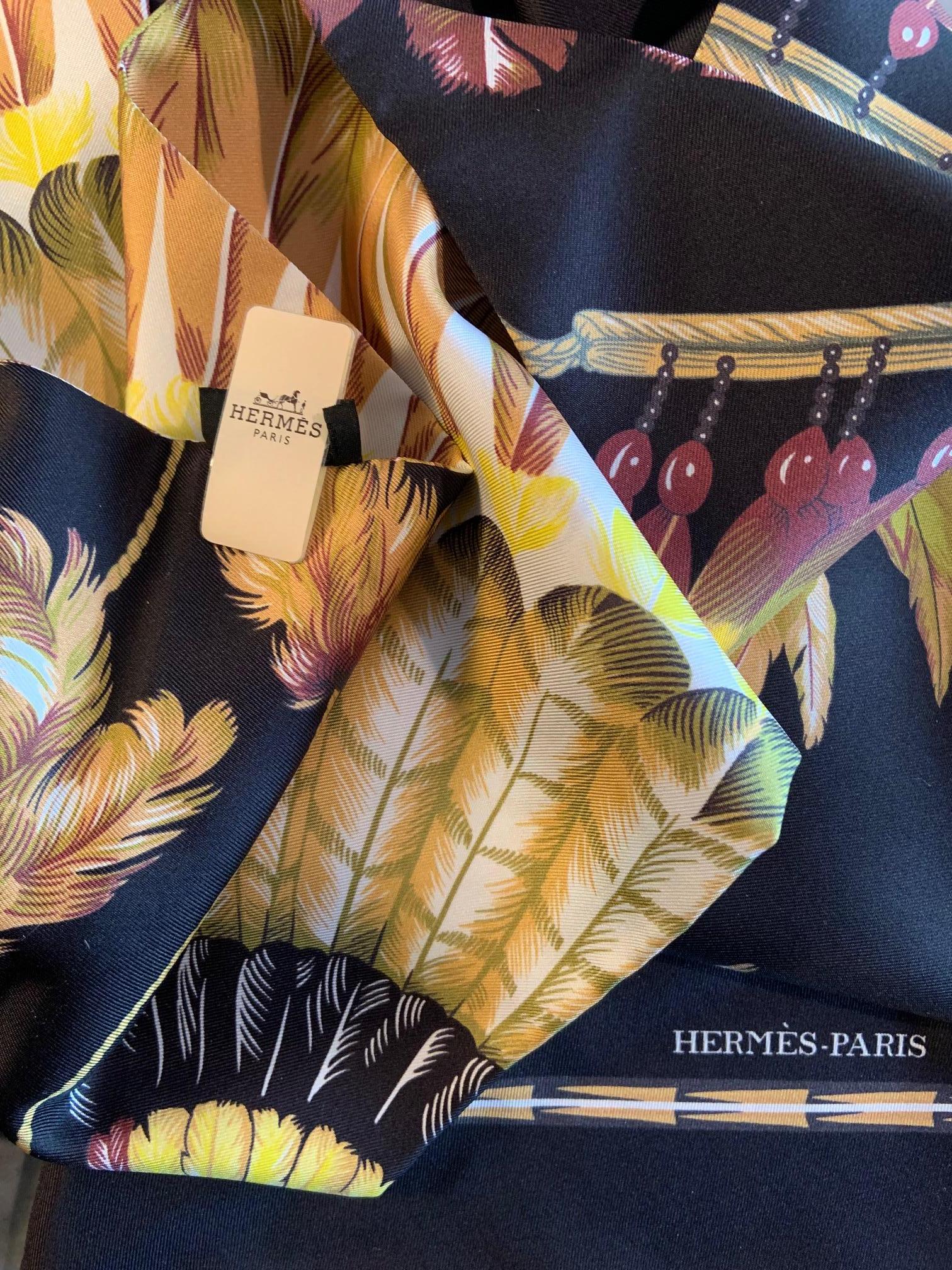 This Hermes Maxi Twilly scarf is in the Brazil pattern with a black background and many shades of yellow, brown, grey, green and white. It comes to you with the original tag and box and it is in as new, excellent condition.
Measurements;   20cm    X