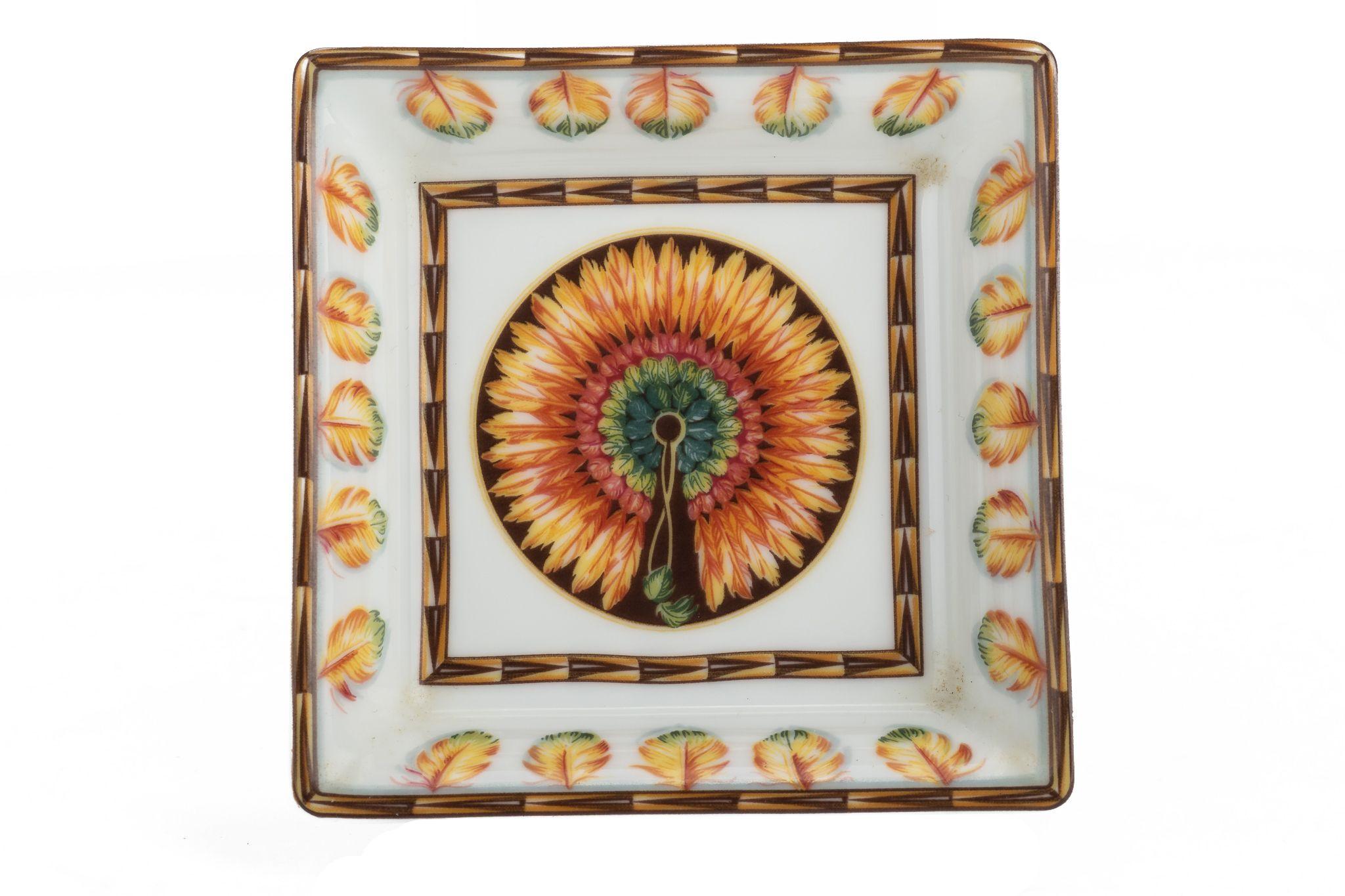 Hermès Brazil Porcelaine ashtray. The piece is square and the paint shows a big pheasant in the center opening is feathers. The tray is in excellent condition and comes with a box.