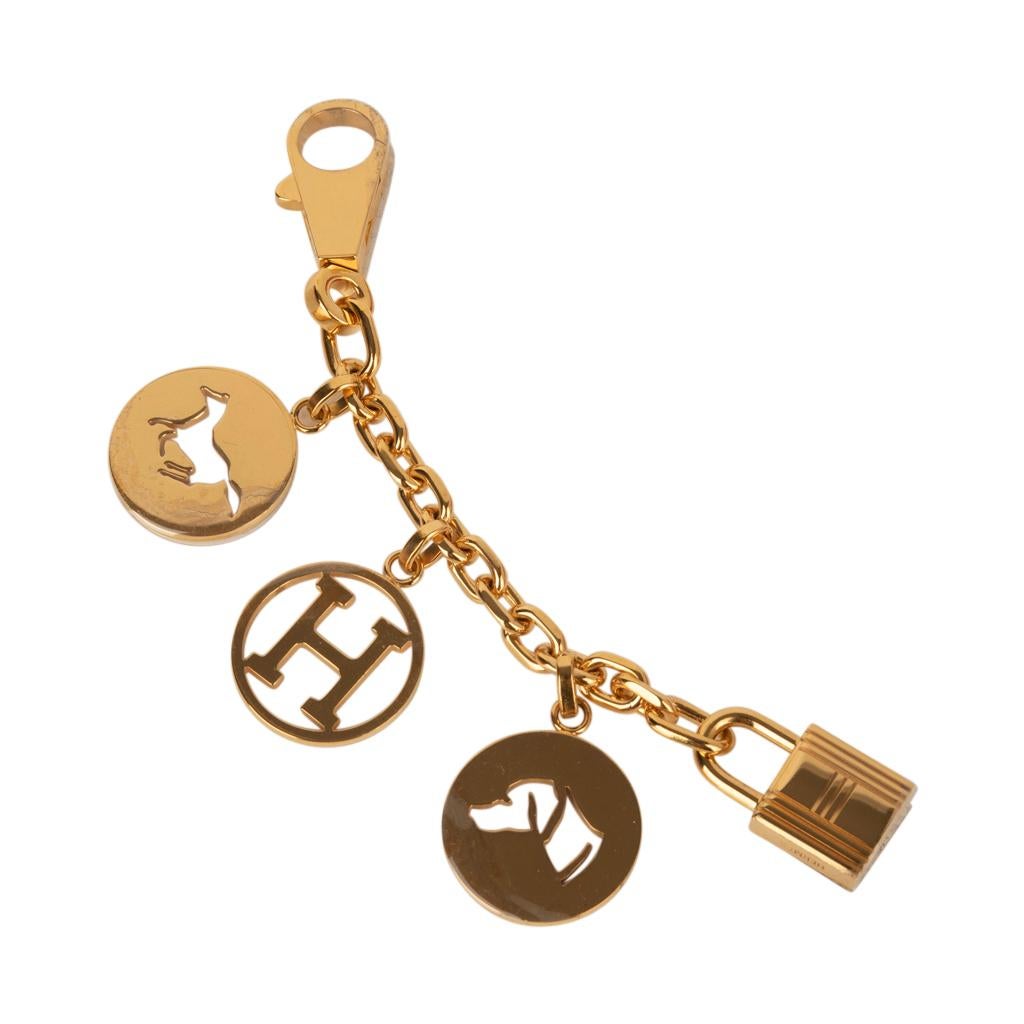 Guaranteed authentic coveted limited edition Hermes Breloque Olga bag charm features 3 signature gold charms.
No longer produced this iconic charm with the horse, dog and H is a marvelous enhancement to any Birkin or Kelly bag.
Claw clasp and lock