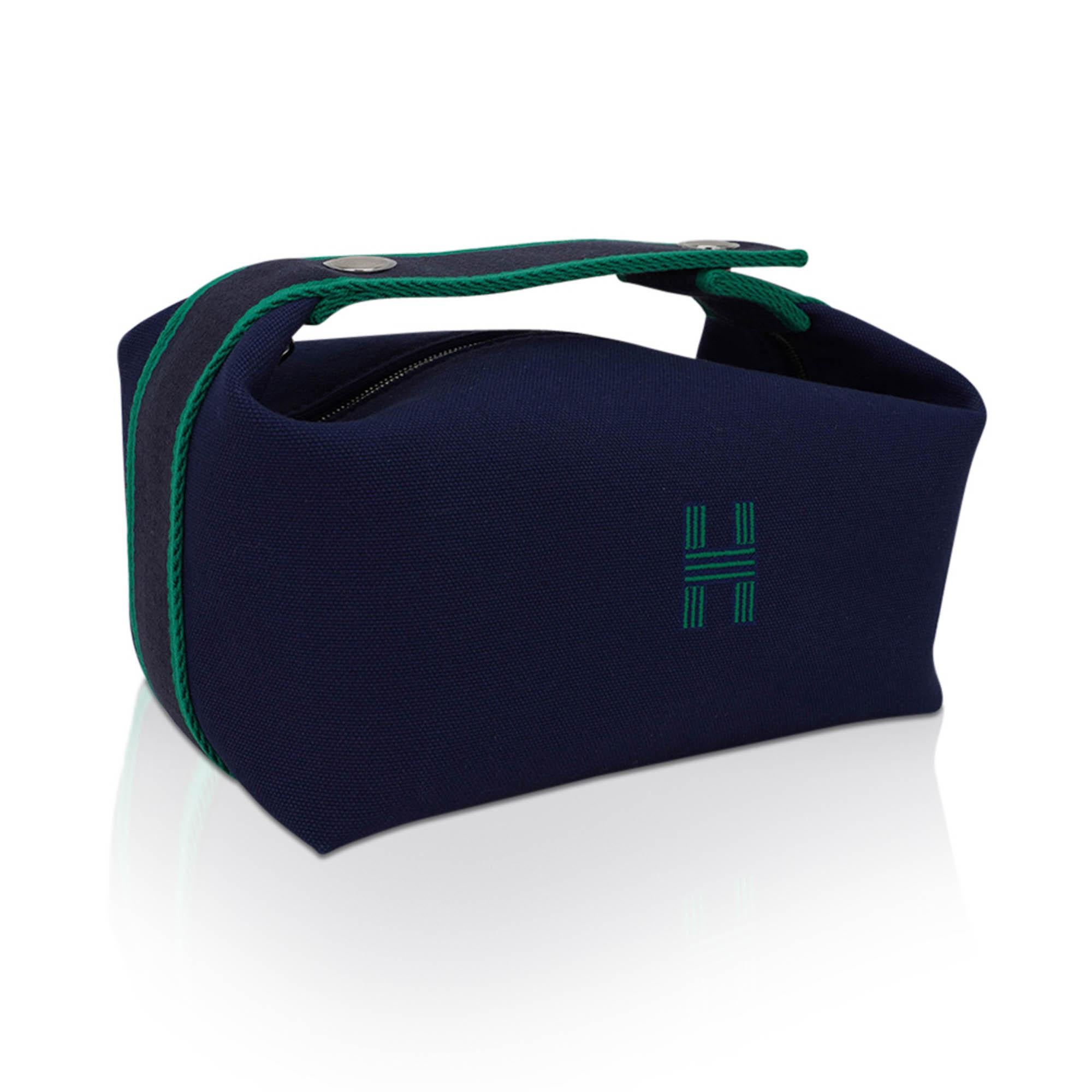 Mightychic offers an Hermes Bride-A-Brac Pencil Case small model featured in Marine H Plume cotton canvas.
The Trousse de Toilette has an embroidered H on the front.
Top strap, inspired by a Gianpaolo Pagni drawing, features an woven Rouge zig