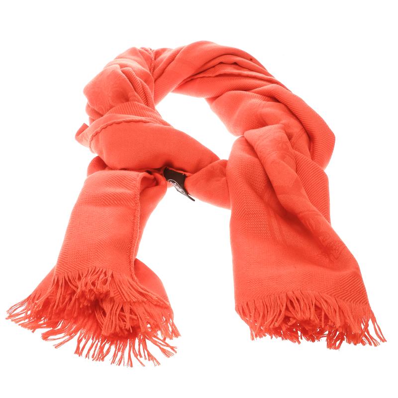 Designed by Sandy Queudrus this stole is from Hermes’ Libris line. With a bright orange color, the silk and cashmere blend is woven with an intricate yet subtle jacquard pattern. The edges are frayed and add to the design. Subtleness and elegance