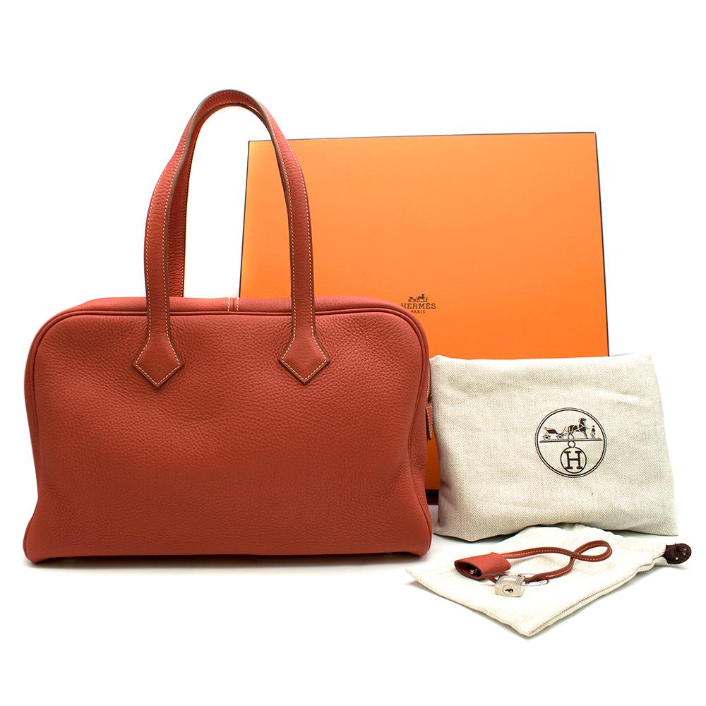 Hermes Clemence Leather Victoria II Fourre-Tout 35 Bag

Serial Number: [O]
- Age (Circa): 2011
- Brique: brick red
- Clemence leather - matte, flat-grained, soft and heavy.
- Palladium plated hardware with still plastic intact.
- Two rolled top