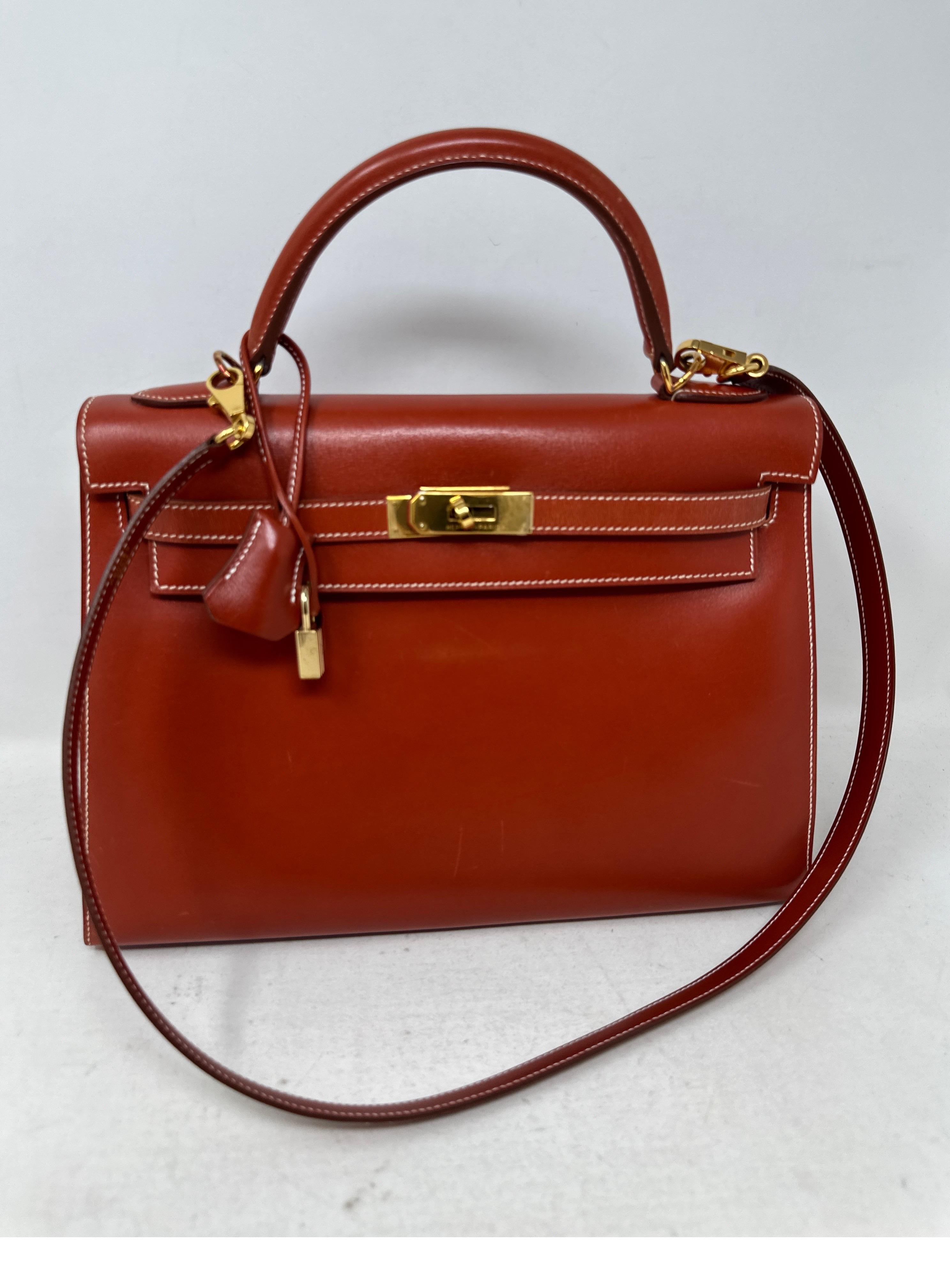 Hermes Brique Kelly 32 Bag. Beautiful swift leather bag. Contrast white stitching. Stunning color with cream leather interior. Clean inside. Corners look great. Light surface scratches in front. See photos please. Overall good condition especially
