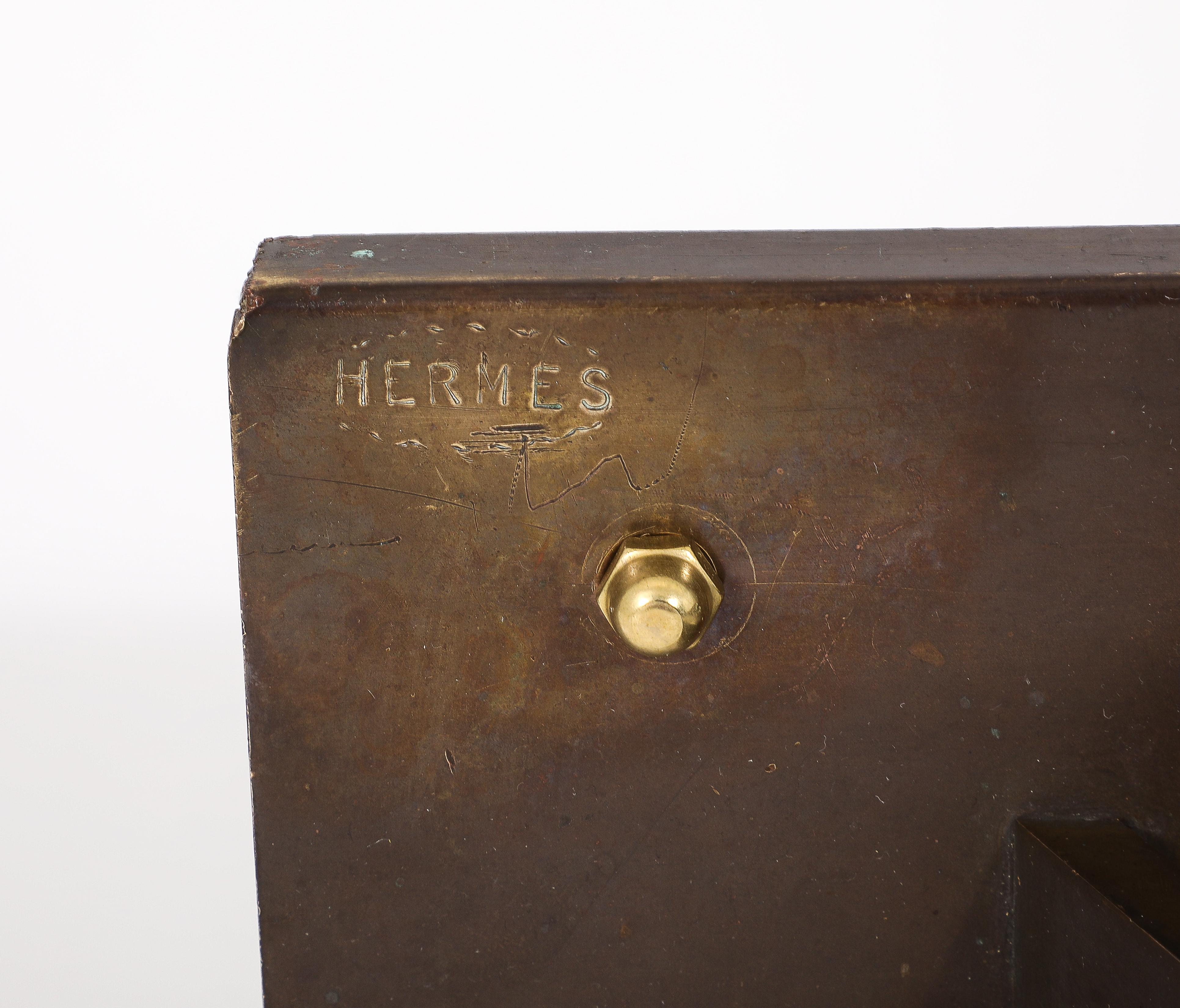 Rare bronze coatrack from a Hermès store display, Great for a chic coatroom or used with a glass atop the triangles it could make an elegant coatrack/Shelf or a striking console.
Signed.
Comes with a heavy duty custom bracket and hardware.