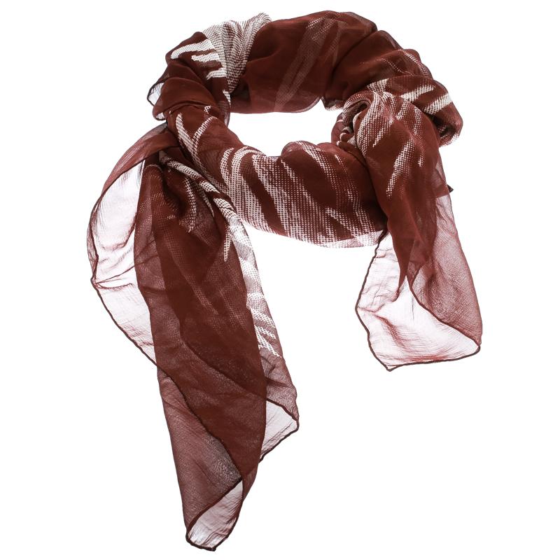 In a mix of brown and white floral prints, this Hermes chiffon scarf is sure to make the best fashion accessory in your closet. It is made from silk and it comes in a square shape.

Includes: The Luxury Closet Packaging, Original Box

