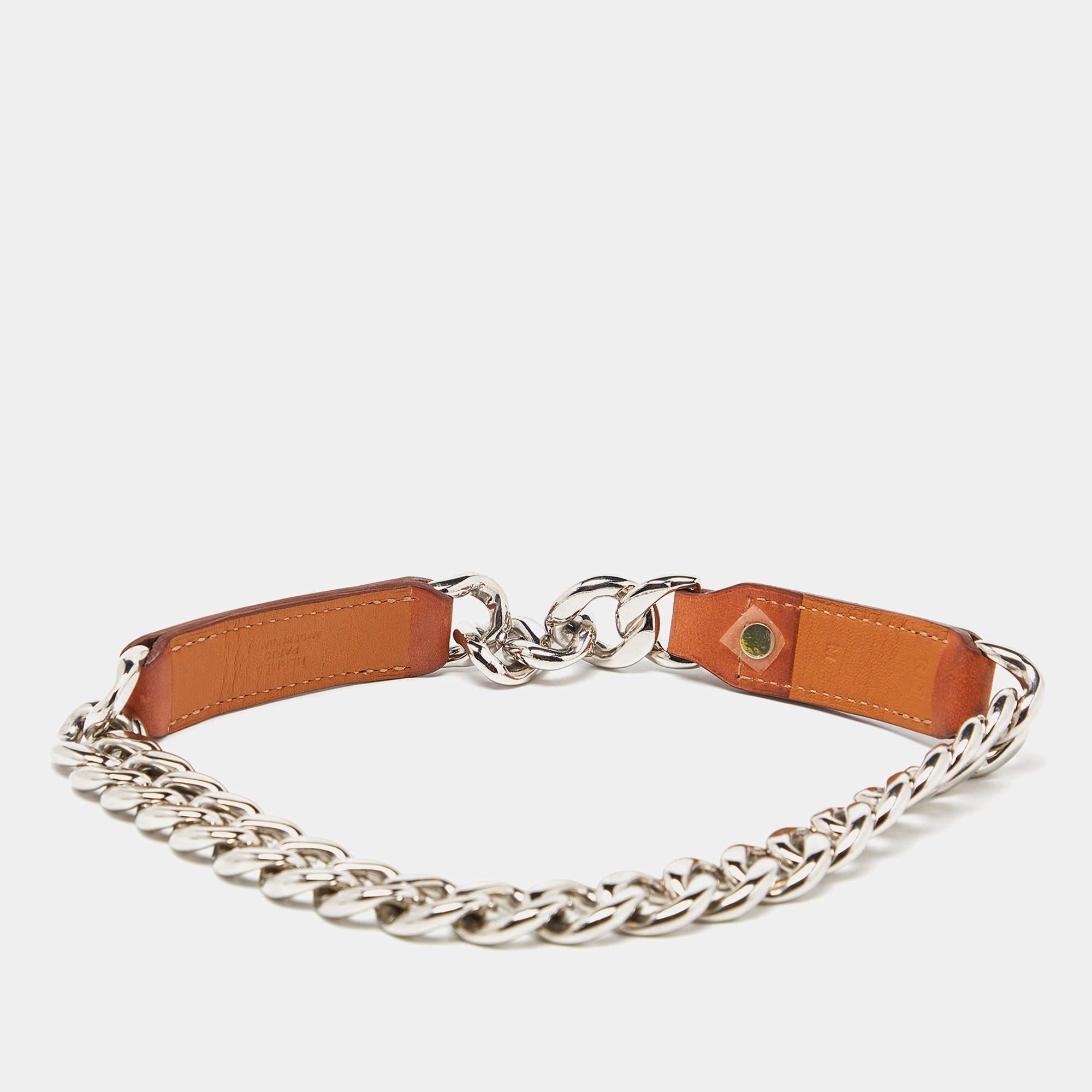 Here's a little something from Hermes for your dog. It is made of brown leather and silver-tone metal, complete with a simple clasp.

Includes: Original Pouch

