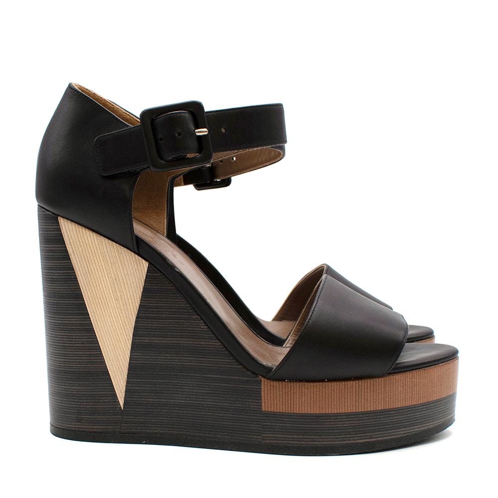 Dark Brown leather Wedged Heels 

- Thick Ankle Strap 
- Matching Leather Buckle
- Leather Trims 
- Geometric Toned Wedges 
- Leather Insole 
- Almond Open Toe 
- Platfrom

Material:
-  100% Leather 

Made in Italy 

Length: 23cm
Insole: