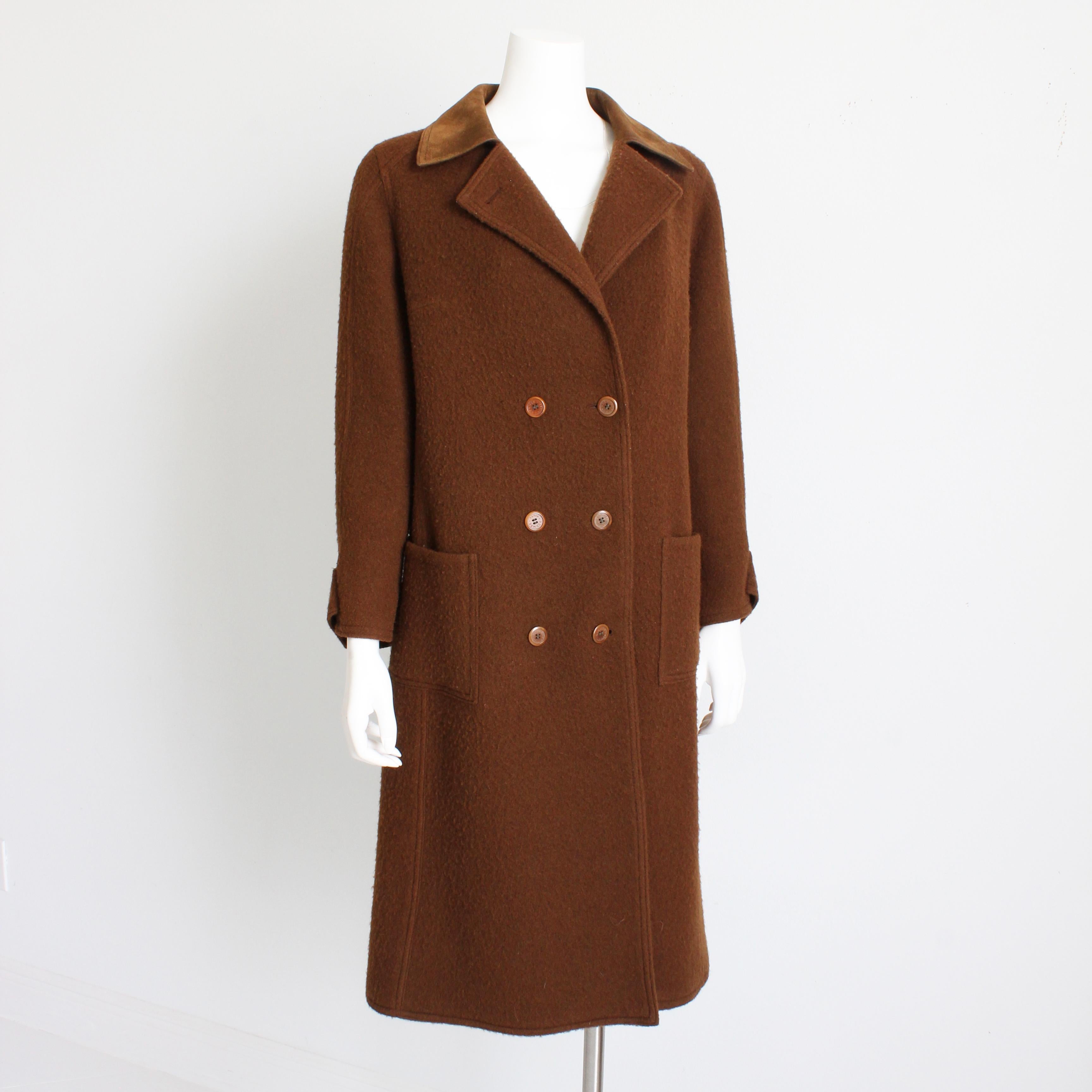 This fabulous coat was made by Hermes Paris, most likely in the late 1970s.  Made from a boiled wool blend in brown, this minimalist style double breasted coat features a supple brown suede collar.  

We love the timeless styling and minimalist