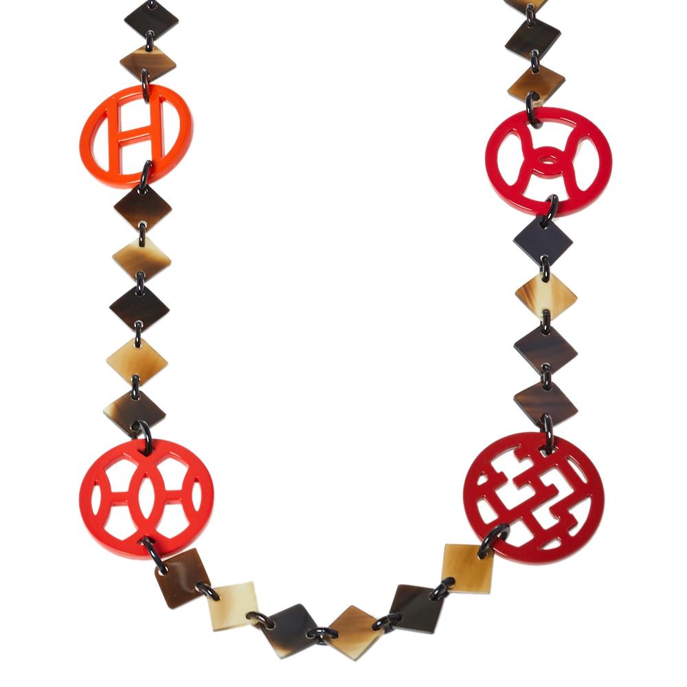 Motifs in horn and wood bring out the beauty of this Lena necklace by Hermes. Signature elements and a simple hook closure add charm to the creation. Made in Vietnam.

Includes: Info Booklet, Original Box