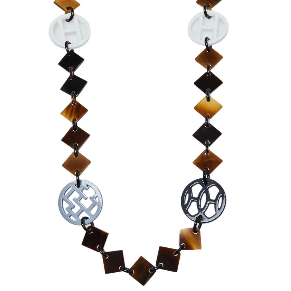 This necklace is from the iconic house of Hermes. It is crafted from quality materials like wood, lacquer and horn, The striking piece has lovely brown hues and is structured as a single strand necklace. Grab it now!

Includes:  Original Box,