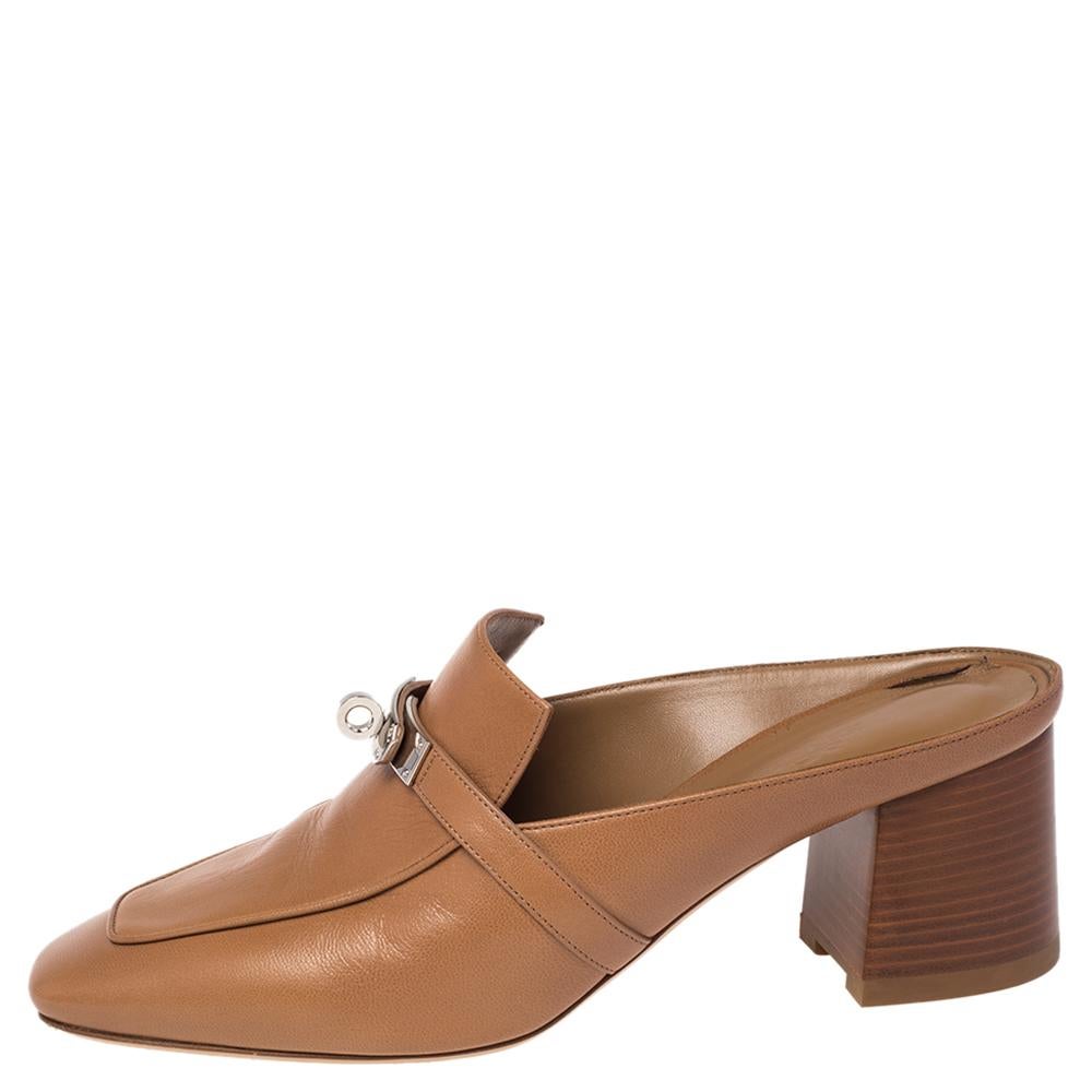 Designed in a loafer style, these Blossom mules are from the house of Hermes. They are beautifully crafted in brown leather and detailed with the signature twist-lock on the uppers. Slip these block-heel mules on for a comfortable look.

Includes:
