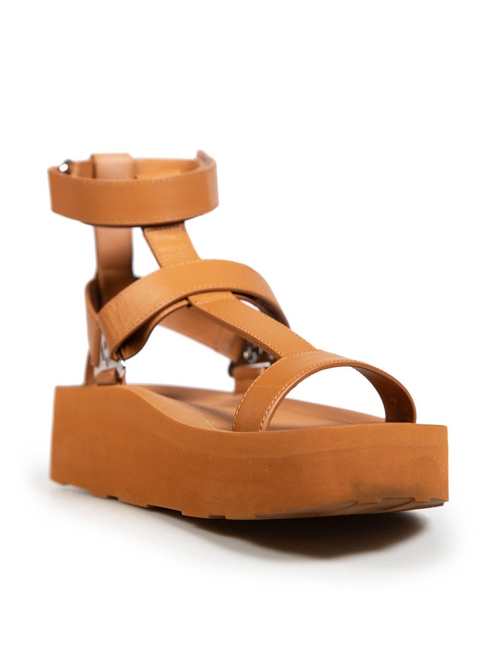 CONDITION is Very good. Minimal wear to the sandals is evident. Light signs of wear to the rims of the platforms on both shoes with discolouration to the front sides and back. General creasing to the leather across both lower ankle straps, the inner