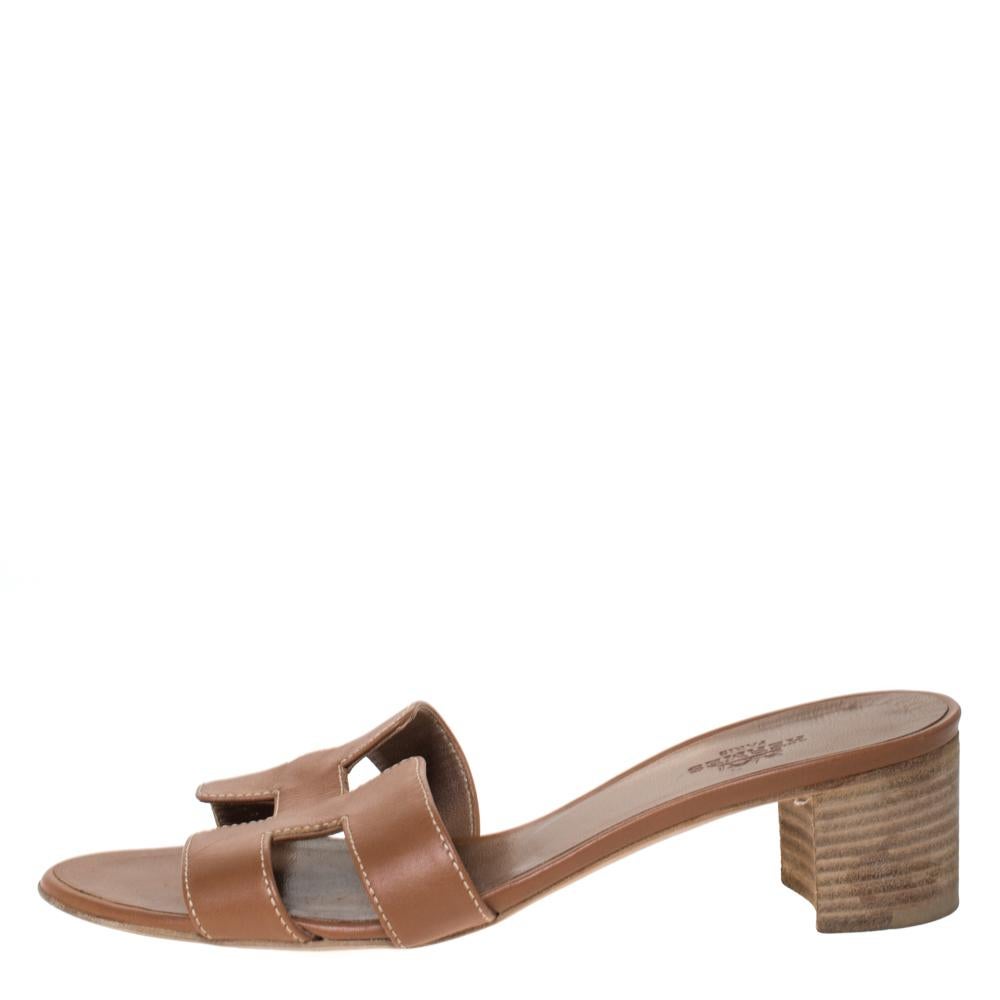 Crafted in brown leather, these Oasis slide sandals from Hermes are classy and comfortable with their wood-finished 4 cm block heels. These slides feature the signature H-shaped straps on the front. The insoles are lined with leather and carry the