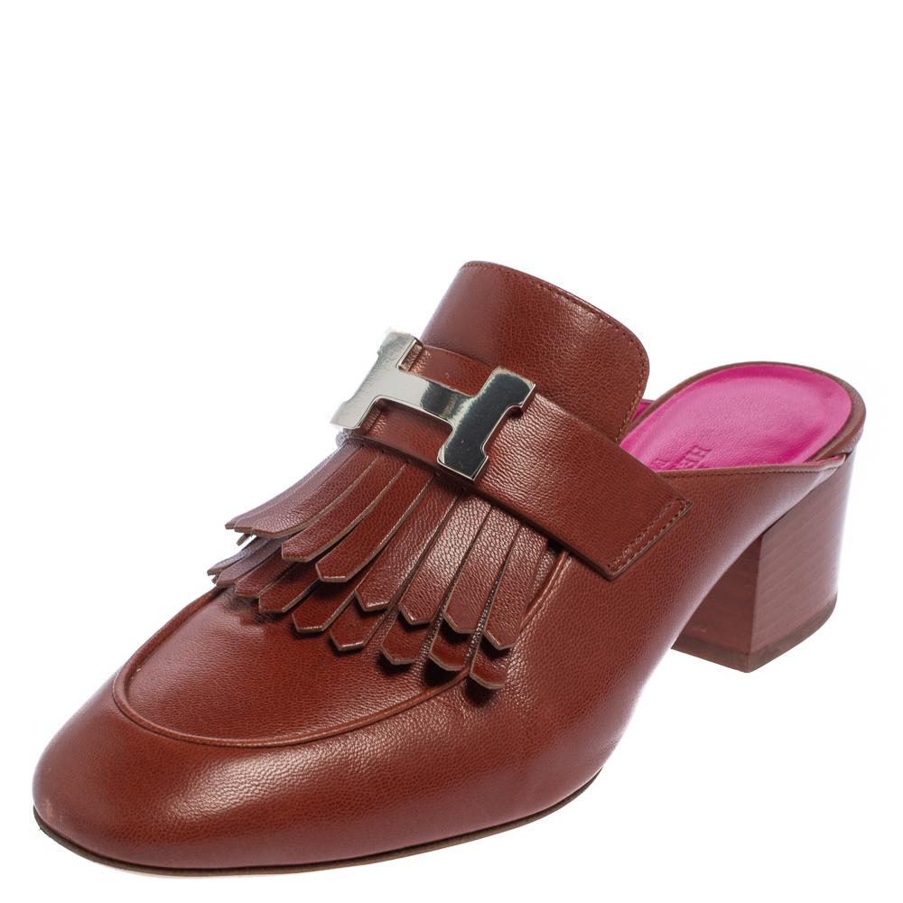 This pair of Tuileries mules by Hermés is a buy to wear and treasure season after season. They've been crafted from brown leather and styled with fringes with the brand's signature H buckle on the uppers. Almond toes and a set of block heels