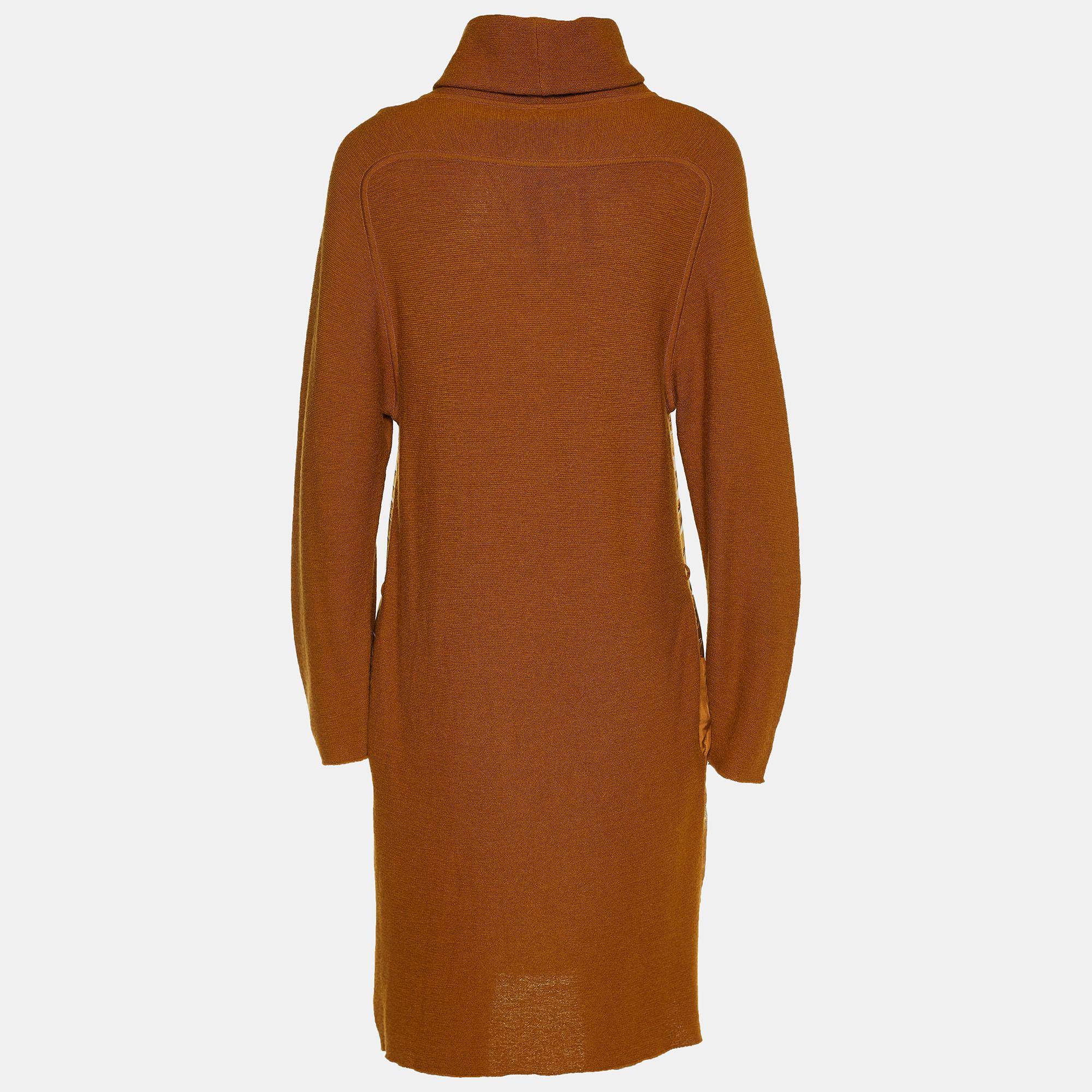 This brown dress from Hermes is made of silk and Alpaca knit and features a lovely printed pattern on the front. It flaunts a high neckline and long sleeves. Pair it with platform sandals and a clutch to rock a fashionable outing.

