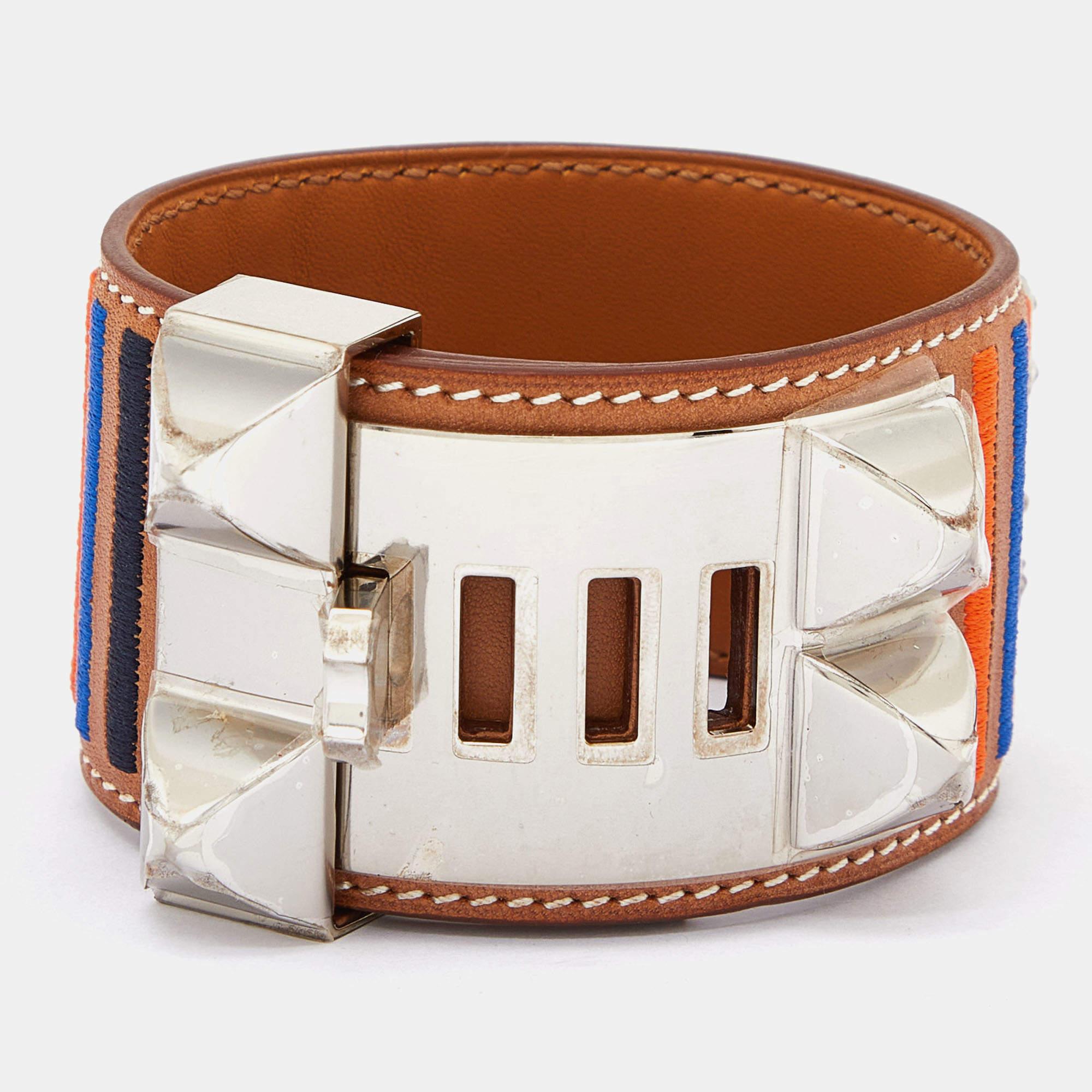 This instantly recognizable bracelet is from the Collier de Chien collection by Hermès. The bracelet, made of striped leather, is adorned with the iconic Collier de Chien motif in palladium-plated metal featuring pyramid studs and a ring. This bold