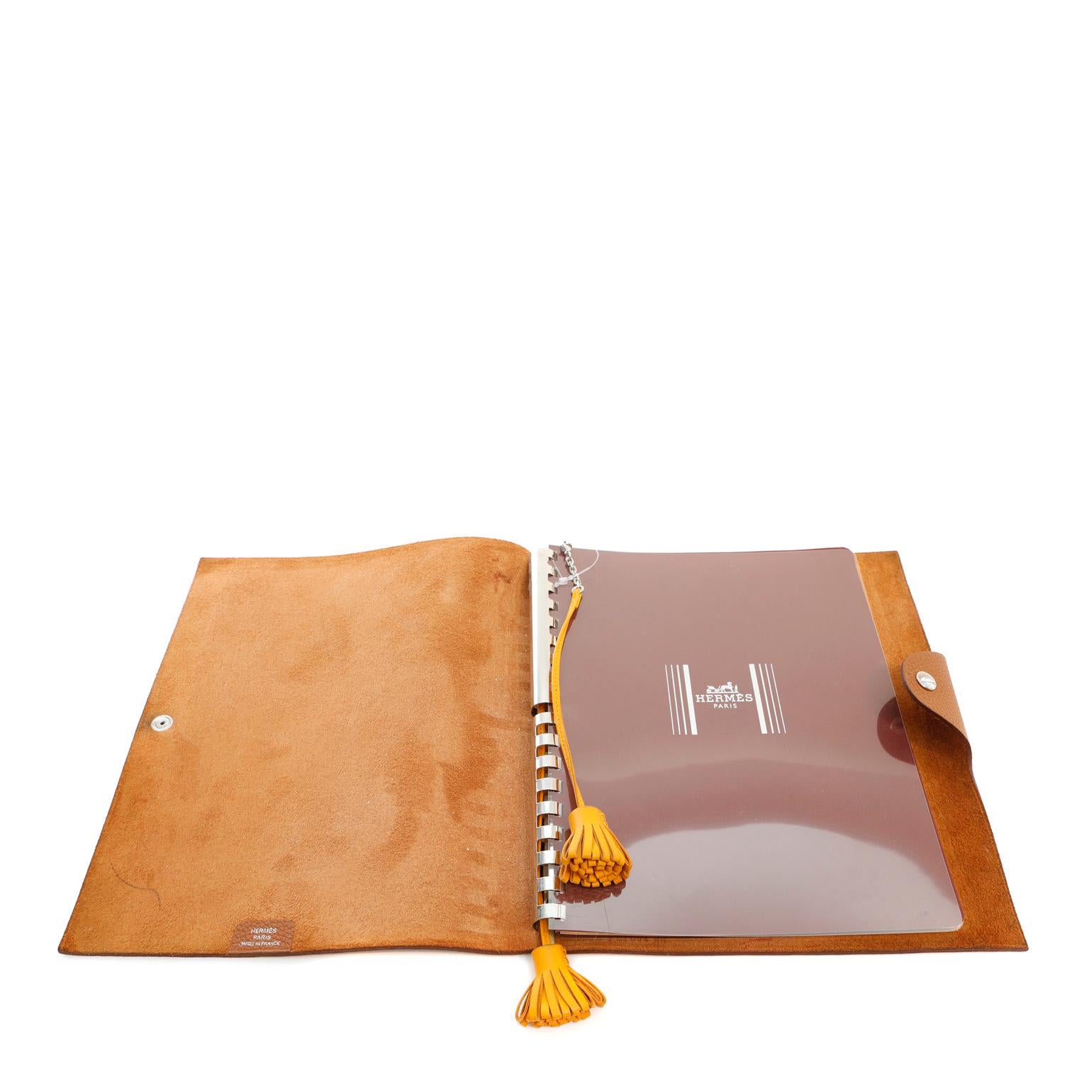 This authentic Hermès Brown Togo Notepad Cover is in pristine condition; never used.  Durable and textured Togo leather snap closure notebook cover is elegant and dignified in golden brown. 9” x 7.5”

PBF 12348