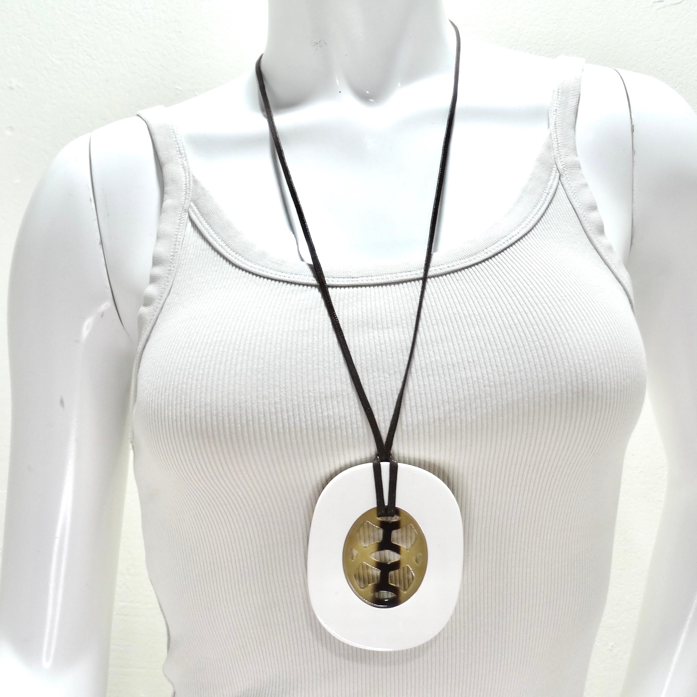 Do not miss out on the Hermes Buffalo Horn Lacquer Lift Necklace, a piece of art that combines the natural beauty of white buffalo horn and lacquered wood to create a unique and luxurious statement necklace. The pendant is a masterpiece of artistry,