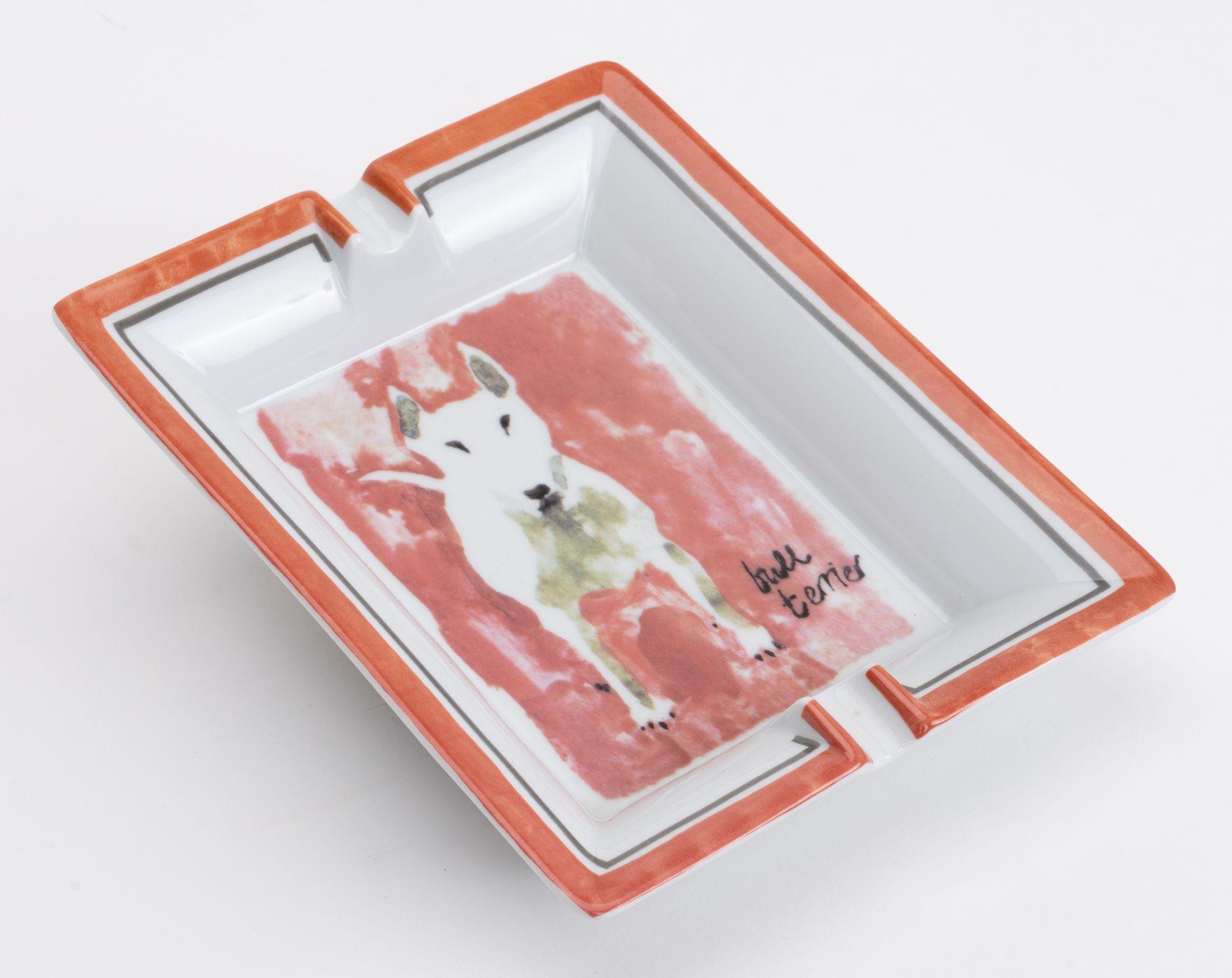 Hermès gold and white porcelain ashtray with bull terrier design. Excellent condition.