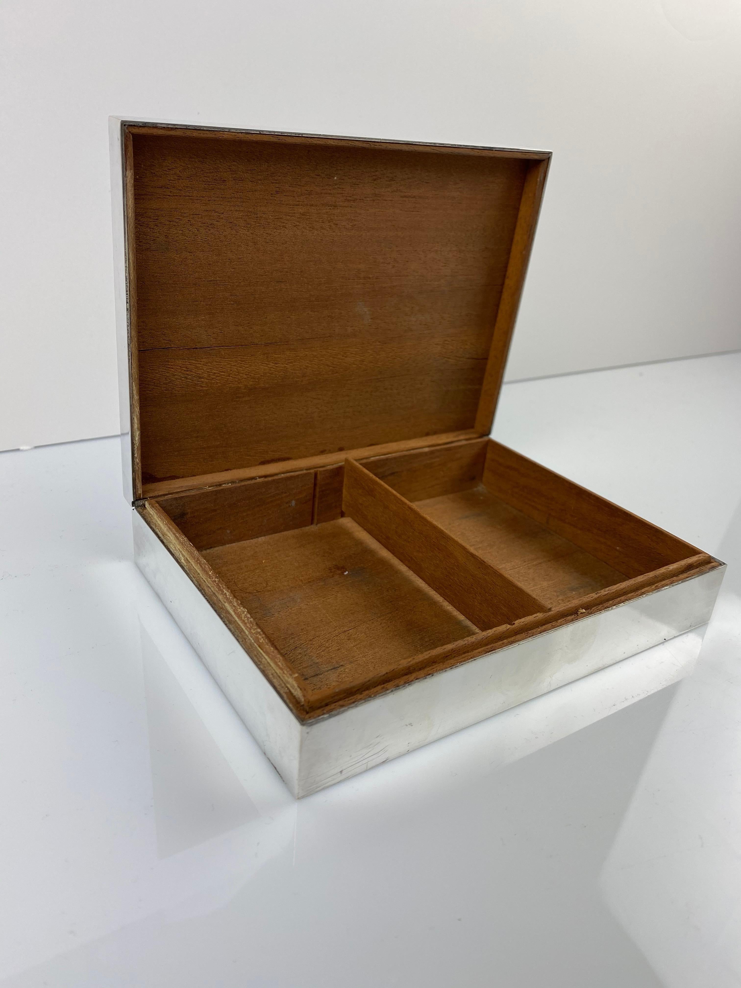A rare and elegant box by Hermès, featuring an engine-turned top surface and 2 shotgun cartridges.