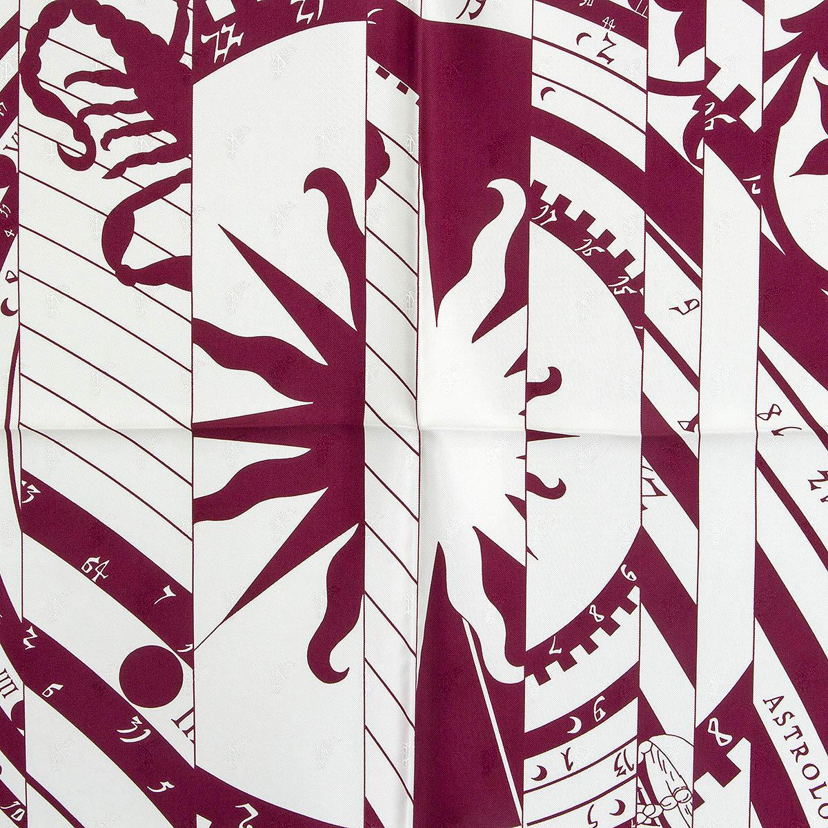 100% authentic Hermès Astrologie Nouvelle Tattoo 90 scarf by Francoise Faconnet reinterpreted by Cyrille Diaktine in burgundy and off-white silk jacquard (100%) with a contrasting pink hem. Has been worn and is in excellent condition. 
Issued in