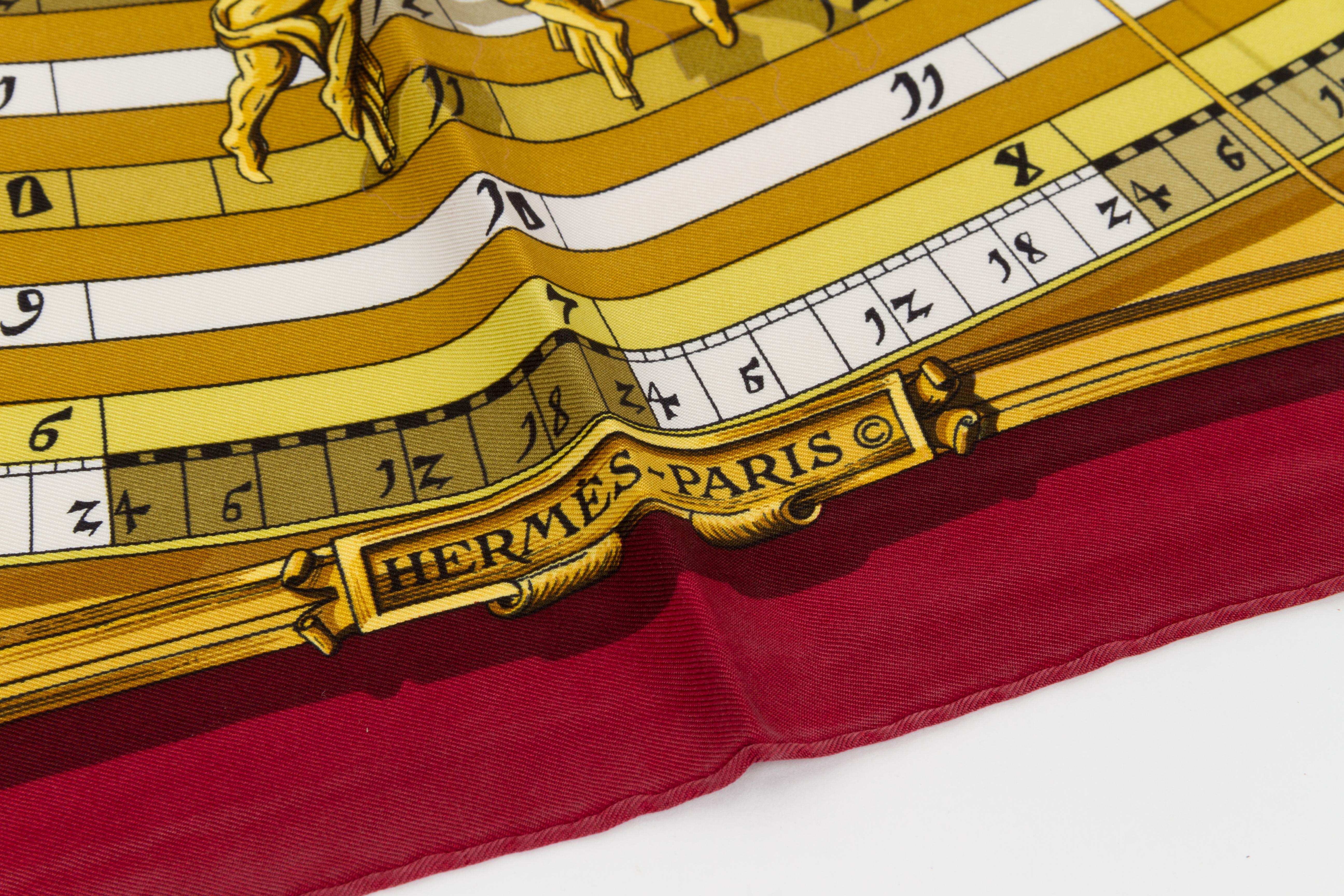 Hermes silk twill Astrologie scarf in burgundy with cream and gold accents. Hand-rolled edges. Minor wear.