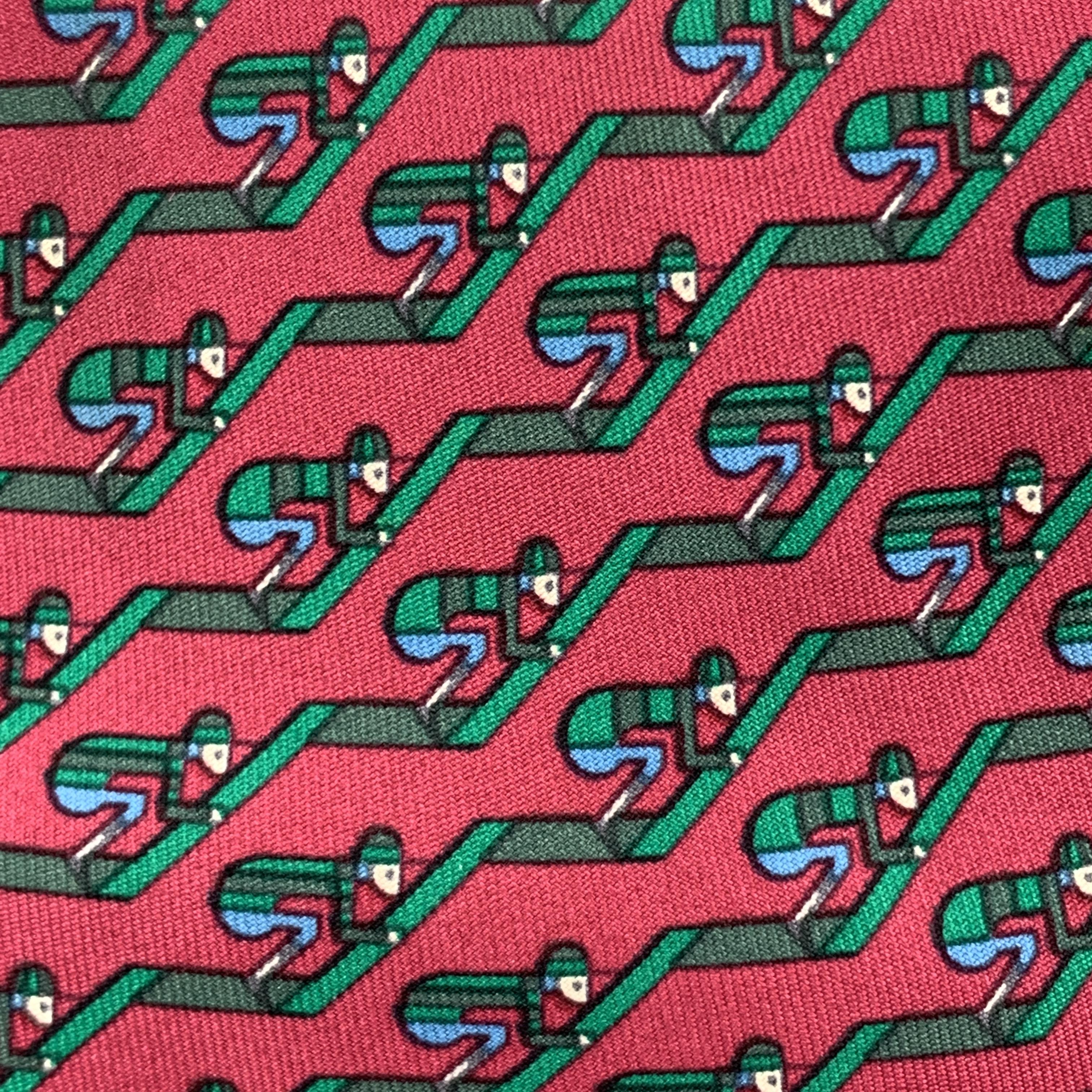 HERMES necktie comes in burgundy silk twill with all over green jockey stripe print. Made in France.

Excellent Pre-Owned Condition.

Width: 3.25 in. 