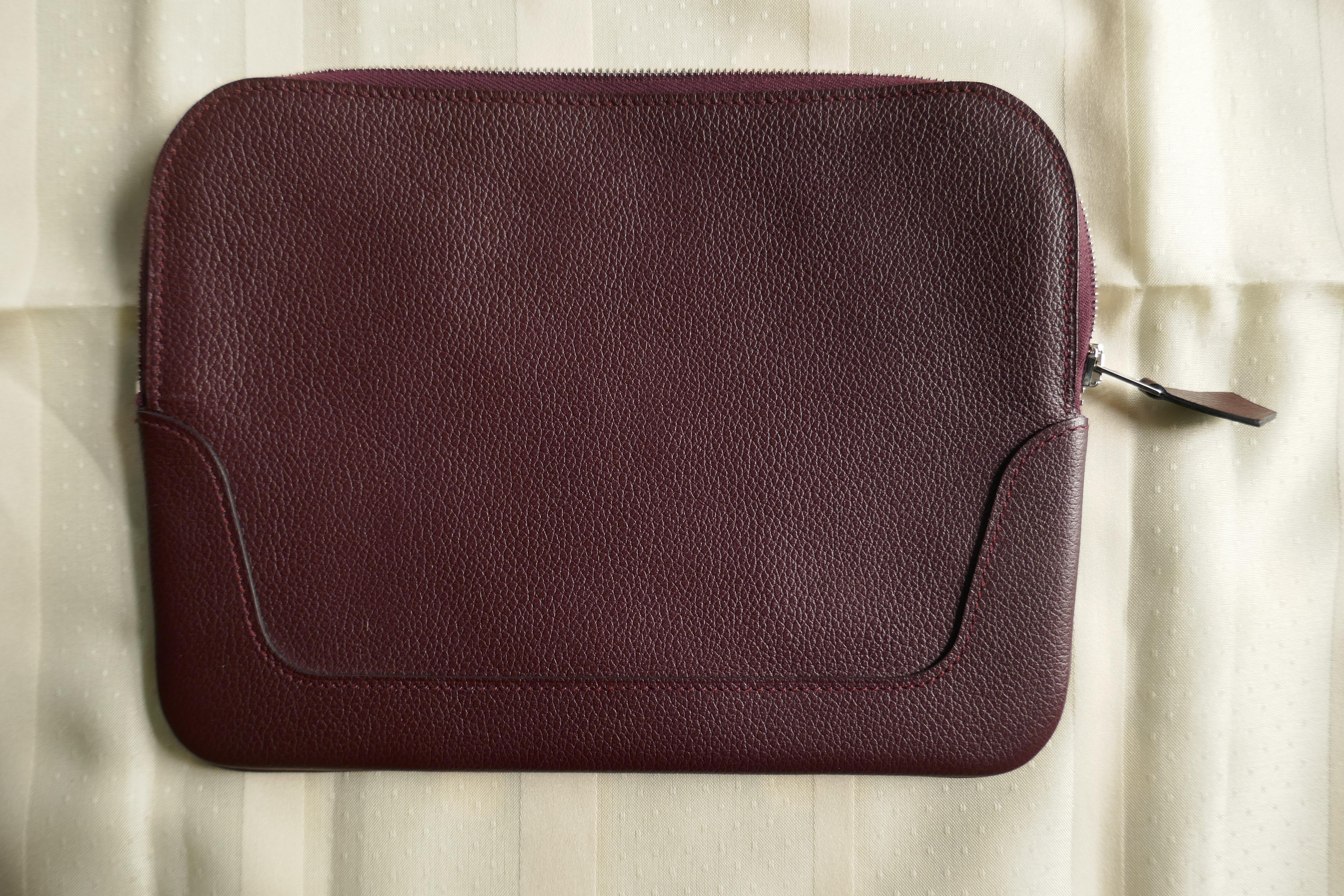 Hermes Burgundy Leather Plum Clutch Bag. Pochette

Totally Authentic, Wonderfully tactile in soft Leather 
Very Soft leather with silver metal zip closure
Fine quality with a roomy interior
The pochette has not been used, and it stored in its