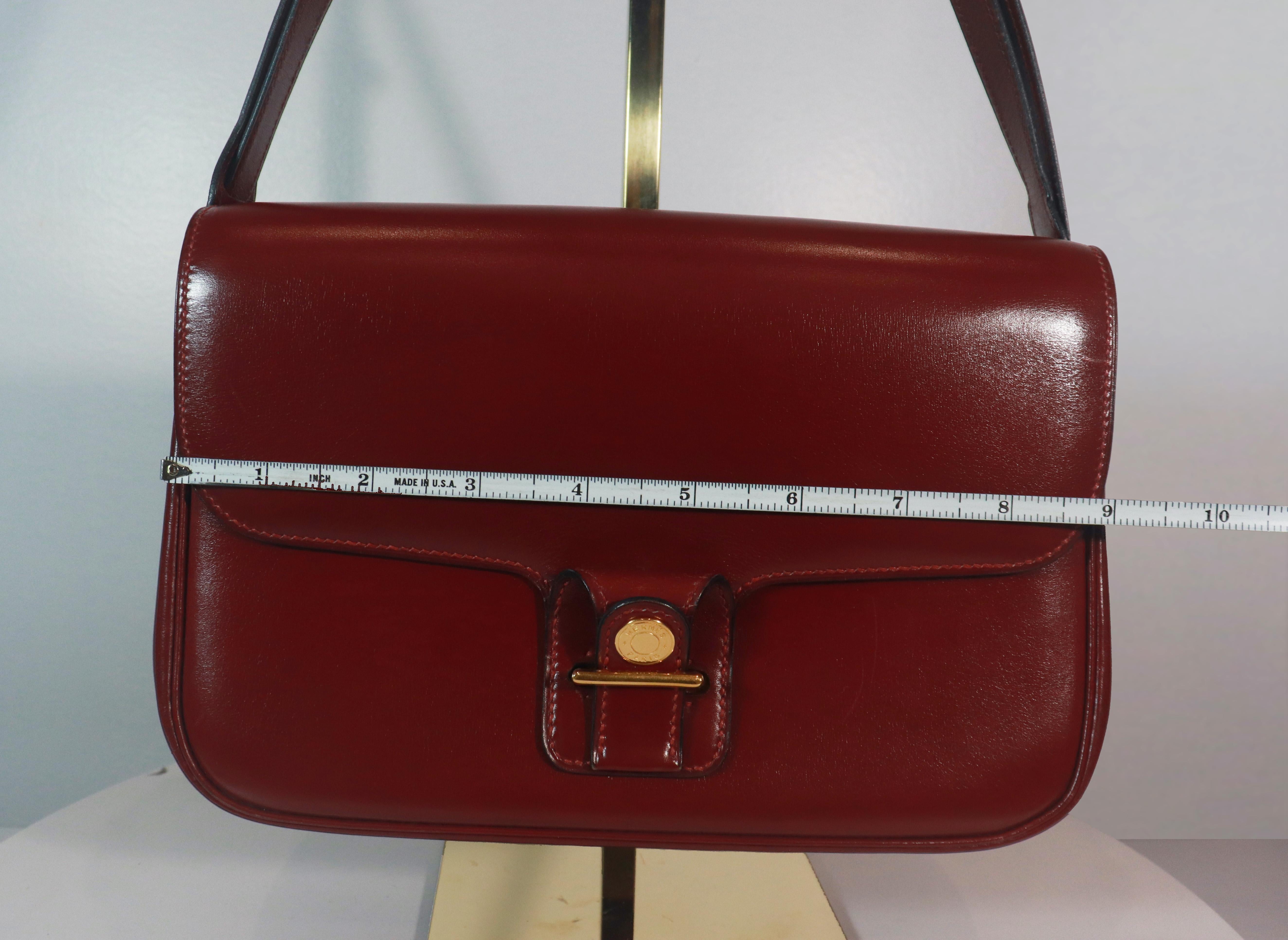 Hermès burgundy leather two-sided crossbody bag with adjustable strap. This crossbody bag is in 'LIKE NEW' condition. There are no significant flaws or wear areas to consider with this lovely crossbody bag. It had been very gently used and carefully