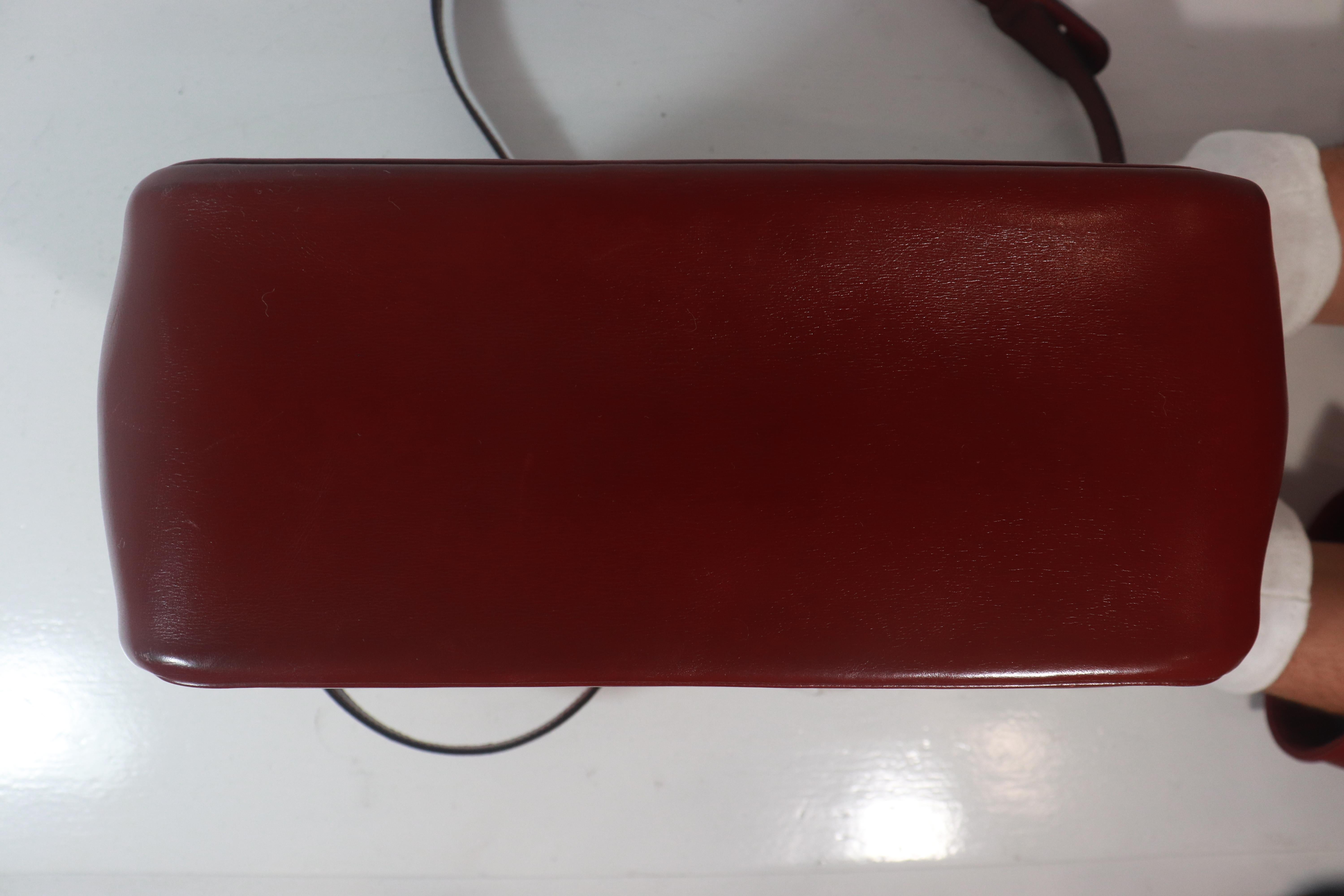 Women's HERMÈS Burgundy Leather Two-Way Crossbody Bag with Adjustable Strap For Sale
