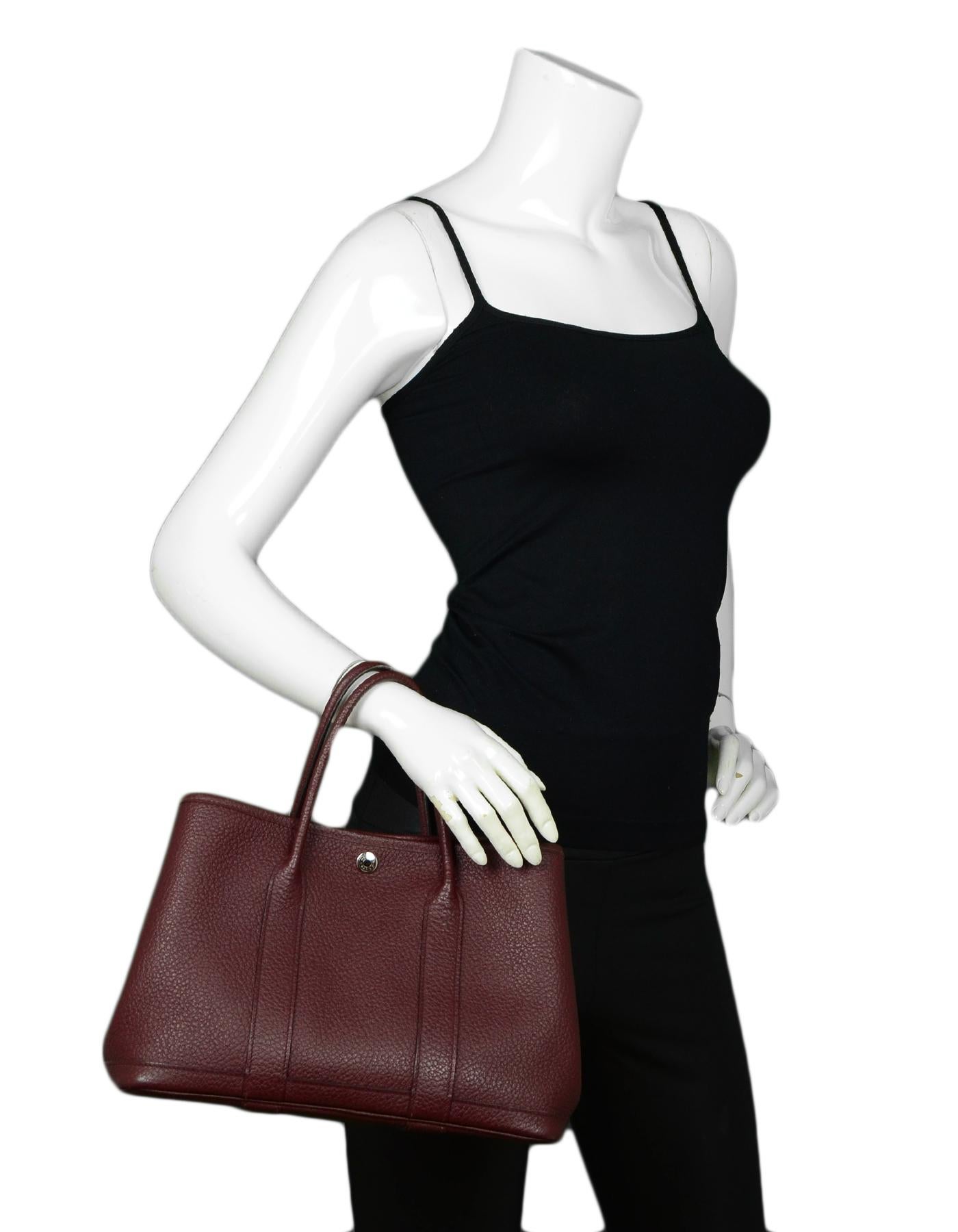 Hermes Burgundy Negonda Leather Garden Party 30 Bag

Made In: France
Color: Burgundy
Hardware: Silvertone
Materials: Leather
Lining: Fine textile lining
Closure/Opening: Open top with middle snap closure
Exterior Pockets: None
Interior Pockets: One