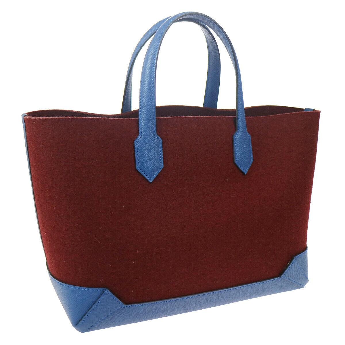 Wool
Leather
Gold tone hardware
Measures 11.75