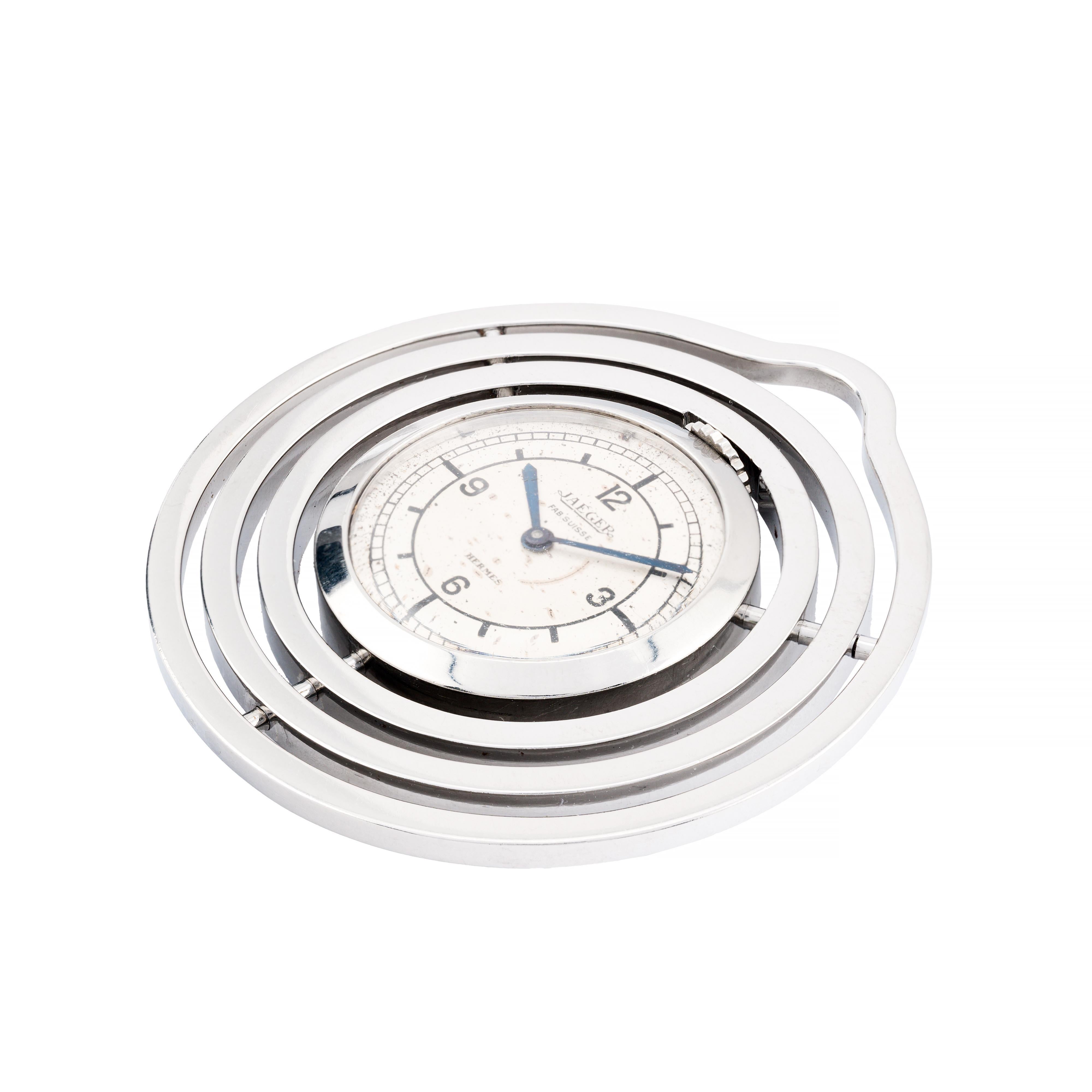 Aston Estate Jewelry Presents:

A rare Jaegar-LeCoultre timepiece retailed and signed by Hermes crafted in stainless steel.

The round spiral case measures 42mm in width, featuring a silver dial. The dual signed dial is marked by crisp black