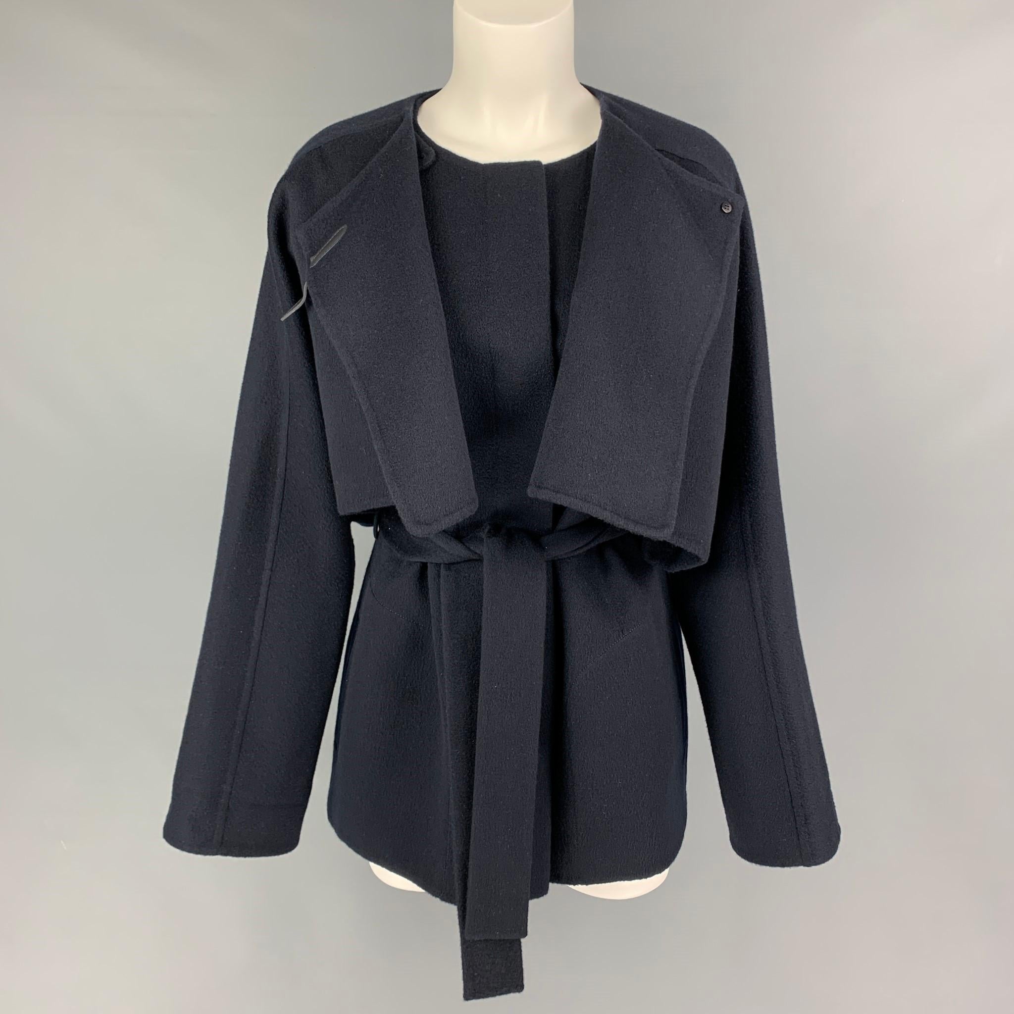 HERMES by Margiela FW 2000 cape & vest comes in a navy blue cashmere featuring a belted design, collarless, leather strap detail, slit pockets, and a logo buttoned closure. Made in France. 

Very Pre-Owned Condition. 
Marked: 42