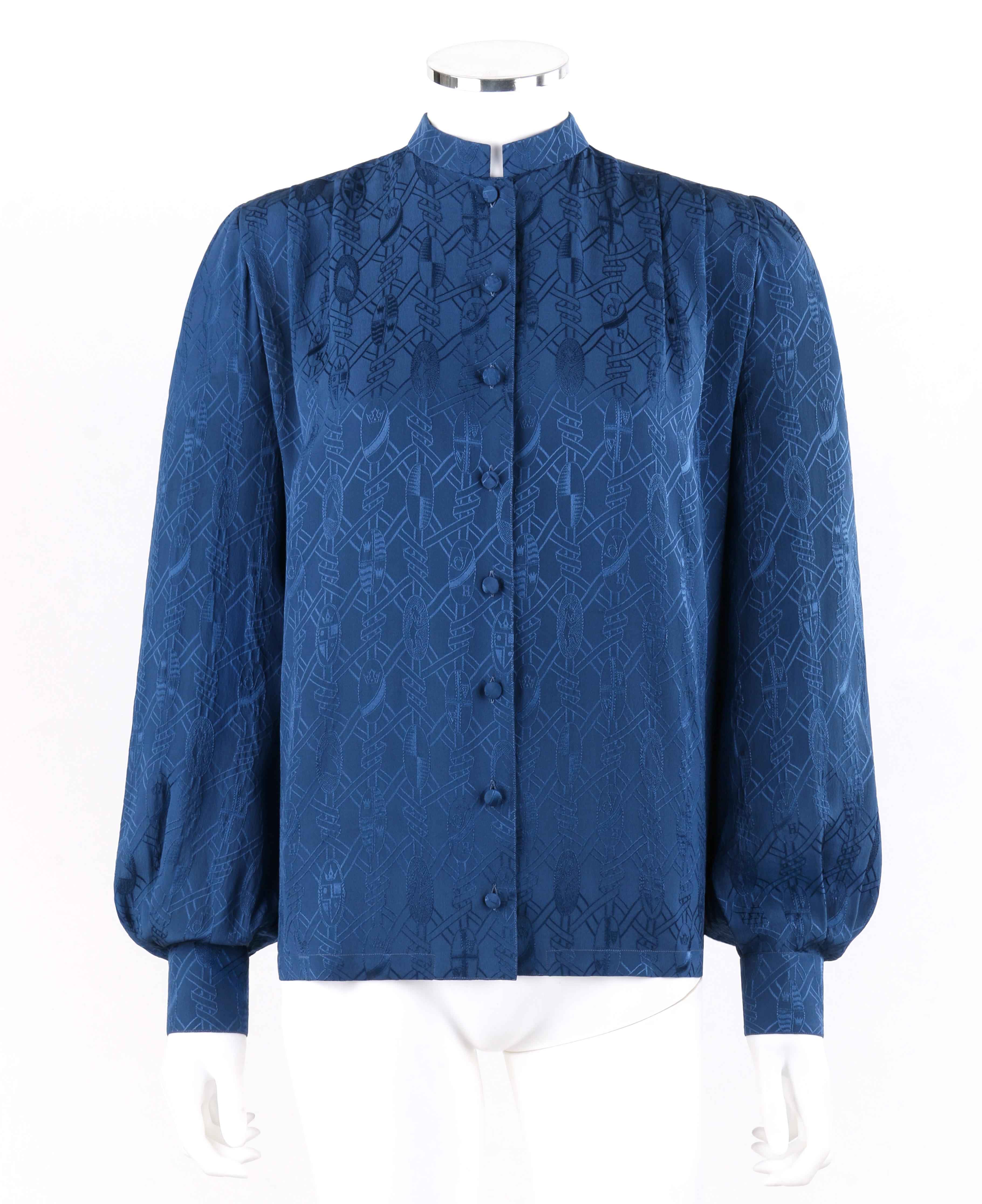 HERMES c.1970s Navy Royal Crest Silk Jacquard Bishop Sleeve Button Up Blouse 
 
Circa: 1970’s
Brand / Manufacturer: Hermes
Style: Blouse
Color(s): Shades of navy blue (exterior, interior)
Lined: No
Marked Fabric Content: “100% silk”
Additional