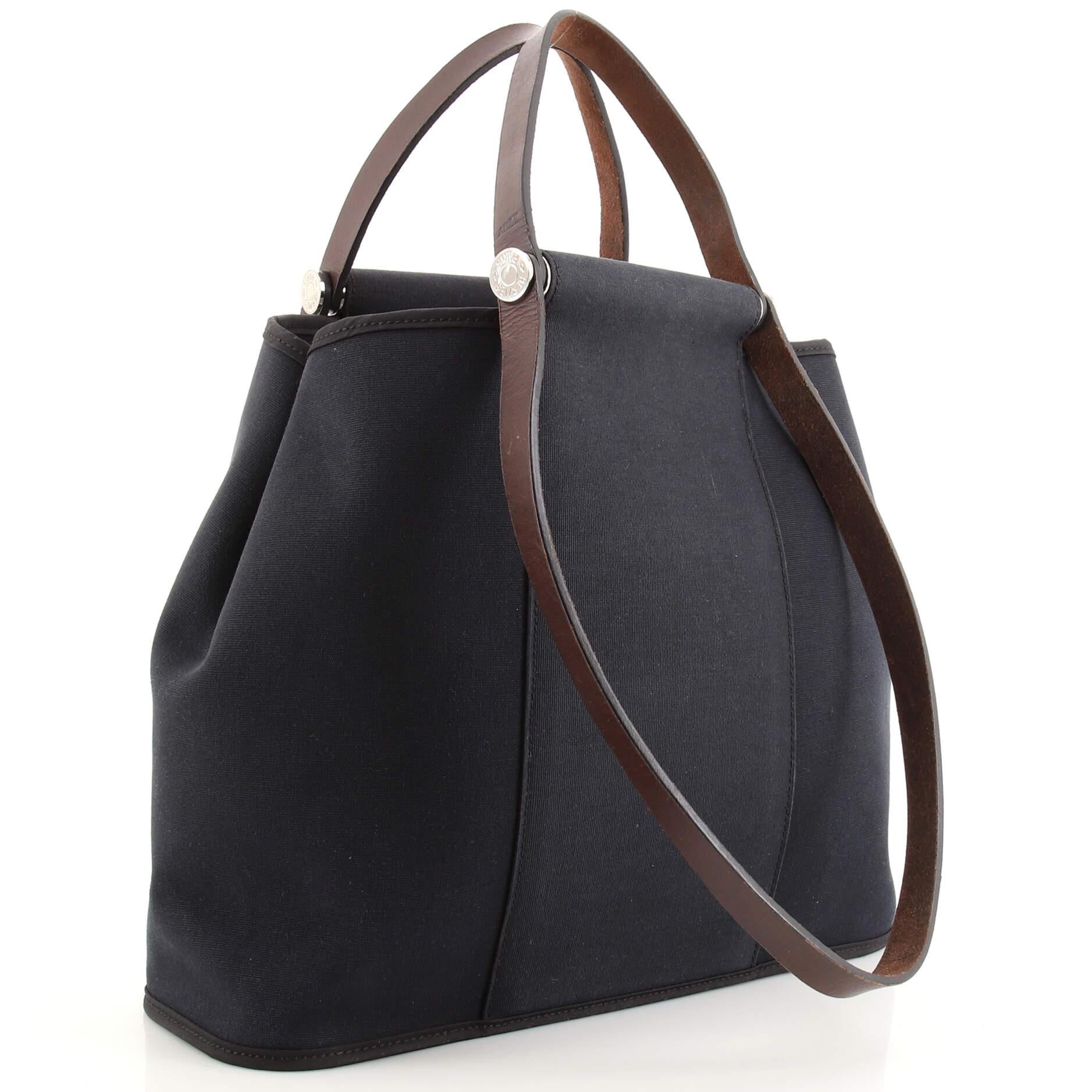 Condition: Fair. Odor in interior. Moderate wear, discoloration, small marks, stains and glitter on exterior and in interior, creasing, moderate wear and scuffs on handles and straps, moderate indentations on rear strap. Peeling on strap wax edges,