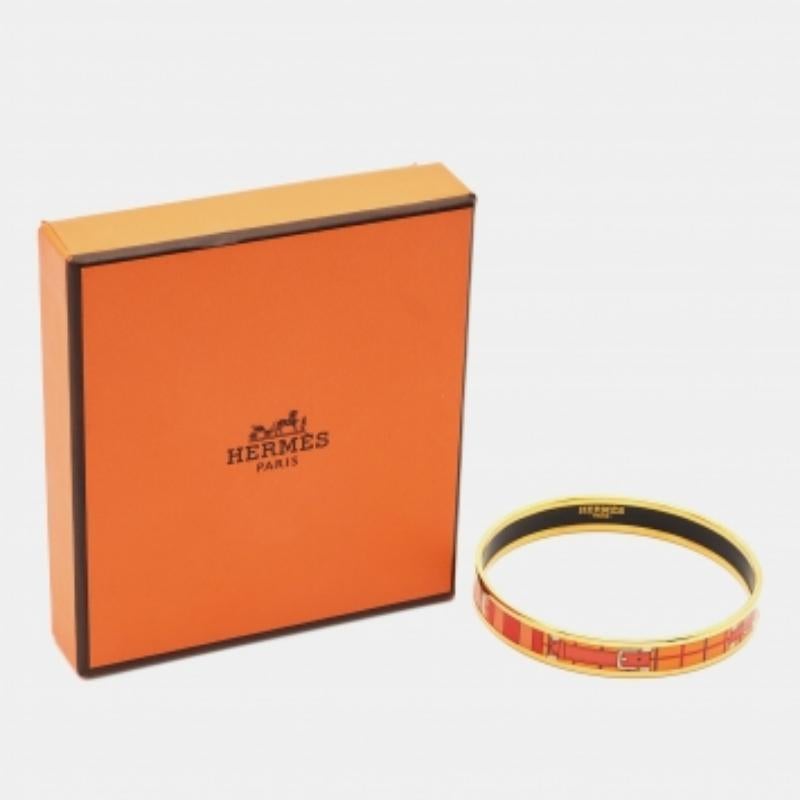 Das Armband von Hermès ist ein luxuriöses Accessoire. Das schlanke, mit Präzision gefertigte Design ist mit glänzendem Gold überzogen und mit exquisiten Emaille-Details versehen. Dieses elegante Stück strahlt zeitlose Raffinesse und tadellose