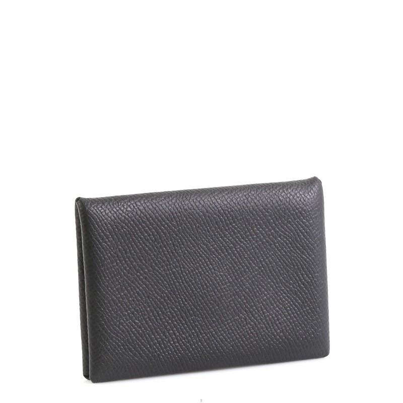 This Hermes Calvi Card Case Epsom, crafted from Noir black Epsom leather, features palladium hardware. It opens to a Noir black Epsom leather interior. Date stamp reads: X (2016). 

Condition: Great. Minimal creasing on opening corners.
Accessories:
