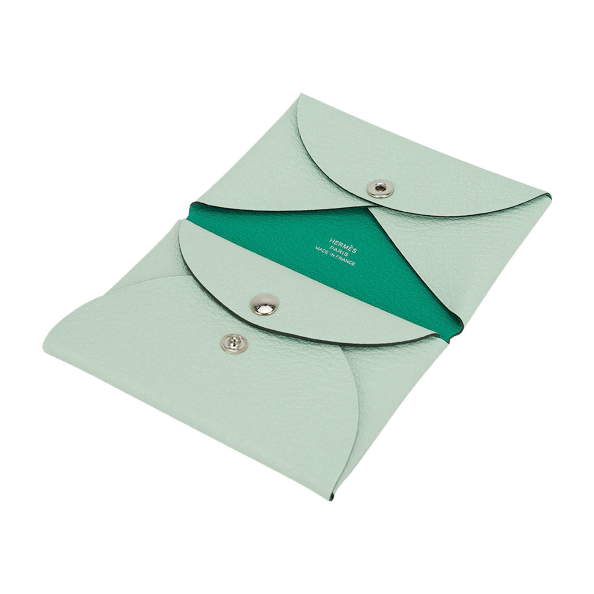 Mightychic offers a rare limited edition Hermes Calvi Duo Verso card holder featured in Vert Fizz and Menthe Chevre leather.
The new design is clever play on folds of leather that is so functional.
One slot for business / credit cards and a snap