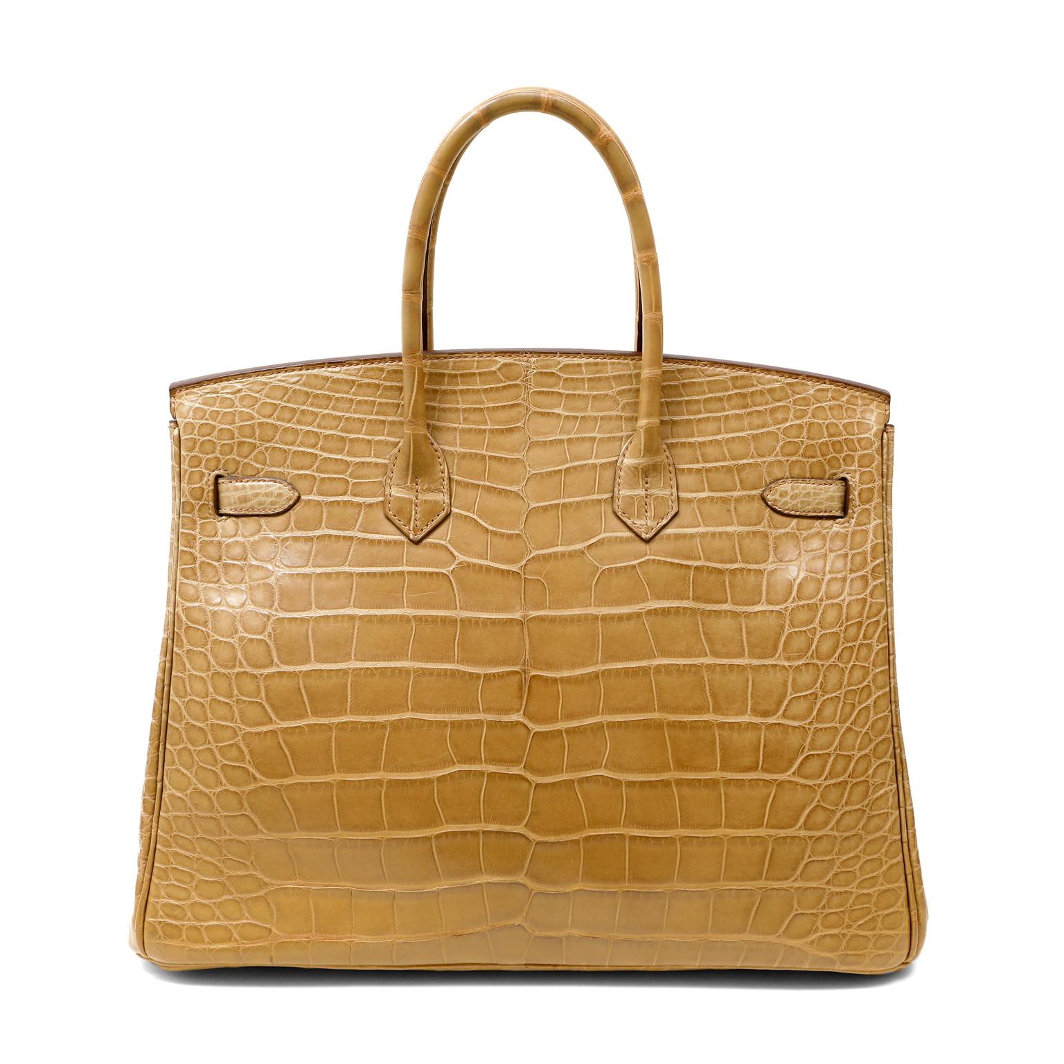 This authentic Hermès Camel Crocodile 35cm Birkin is in excellent plus condition.  Incredibly rare and specially ordered, this exotic Birkin is truly stunning in neutral camel with warm gold hardware.
Hermès bags are considered the ultimate luxury