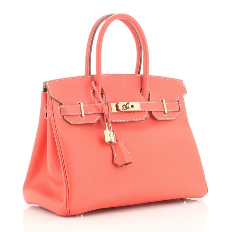 This Hermes Candy Birkin Handbag Epsom 30, crafted from Rose Jaipur pink Epsom leather, features dual rolled handles, front flap, and permabrass hardware. Its turn-lock closure opens to a Gold brown Chevre leather interior with zip and slip pockets.