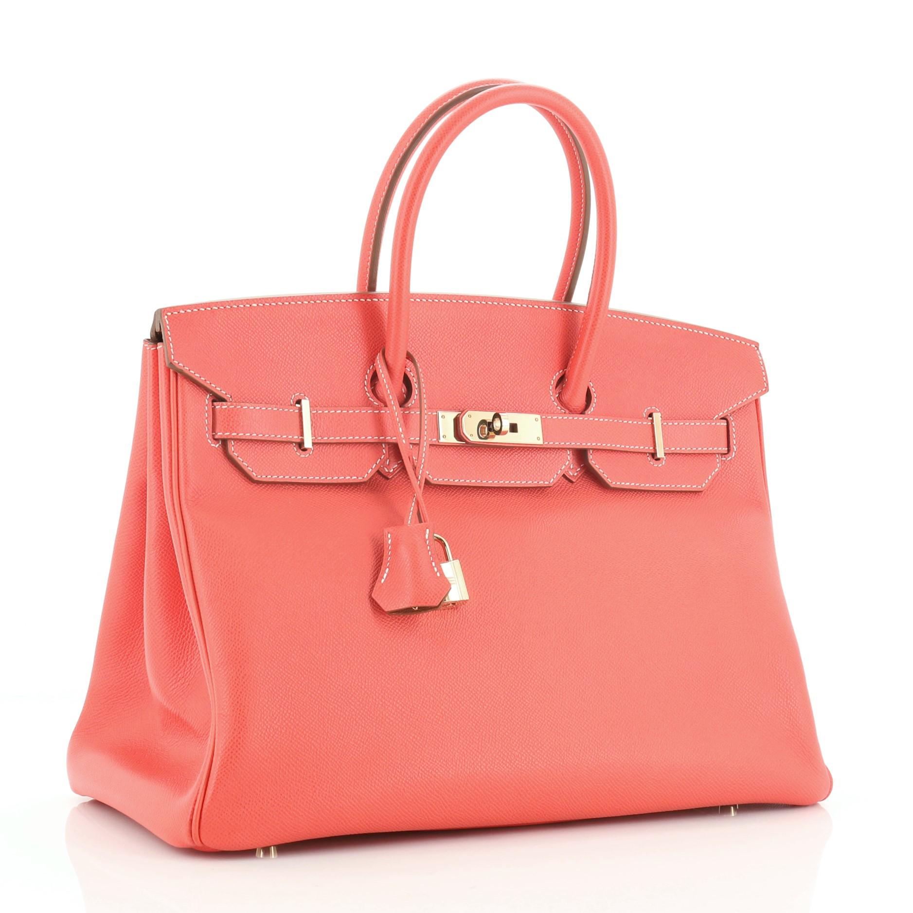 This Hermes Candy Birkin Handbag Epsom 35, crafted from Rose Jaipur pink Epsom leather, features dual rolled handles, front flap, and permabrass hardware. Its turn-lock closure opens to a Gold brown Chevre leather interior with zip and slip pockets.