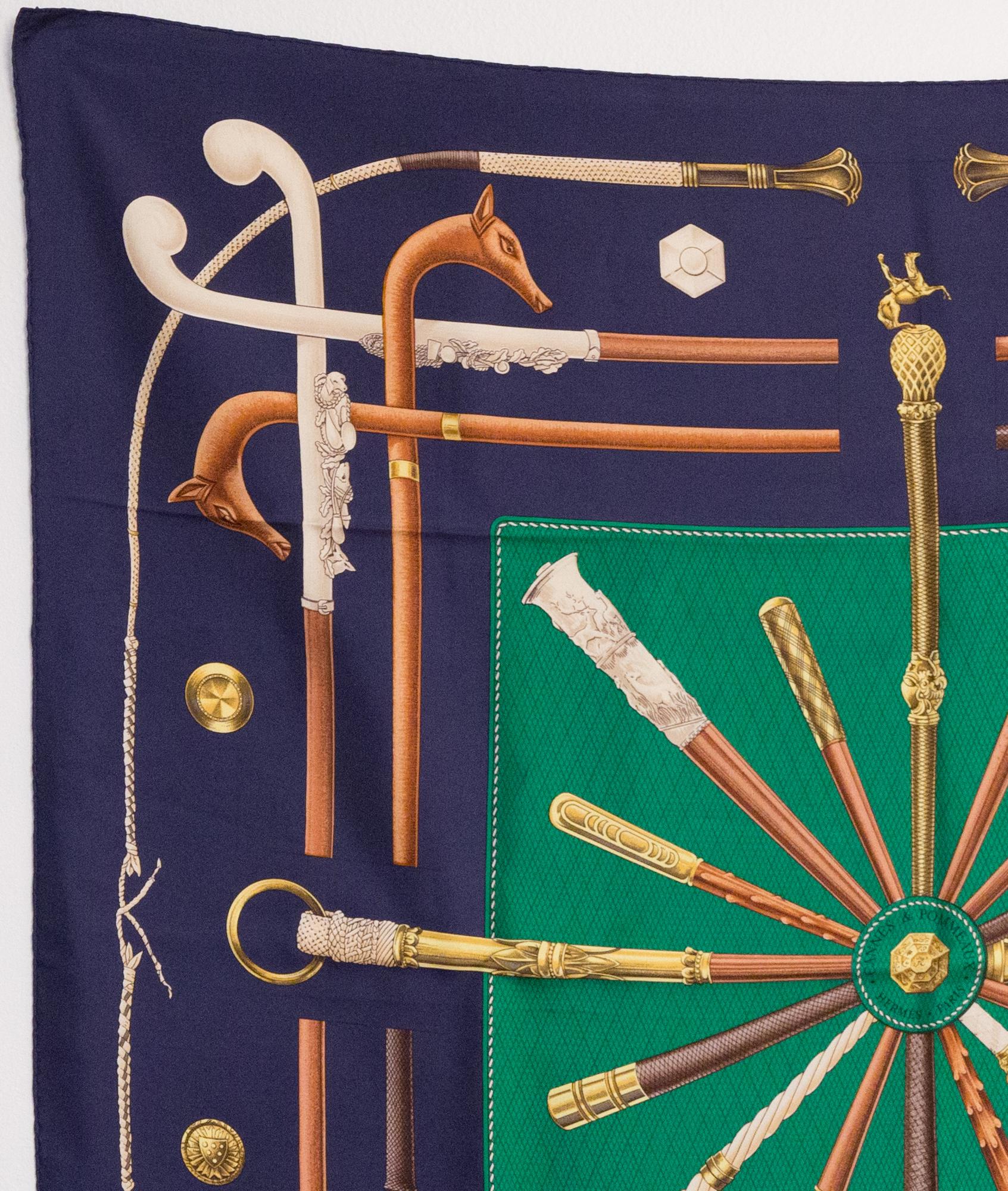 Hermes silk scarf Cannes et Pommeaux by F de la Perriere featuring a navy border, a green center and a Hermès signature. .
The Cannes et Pommeaux was created in 1985.
In good vintage condition. Made in France.
35,4in. (90cm)  X 35,4in. (90cm)
We