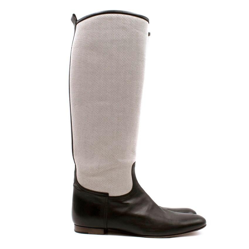 Hermes Canvas Riding Boots

-Canvas pull on riding boots
-Black leather trim and base of boot
-Pull tabs at the back
-Leather interior

Please note, these items are pre-owned and may show signs of being stored even when unworn and unused. This is