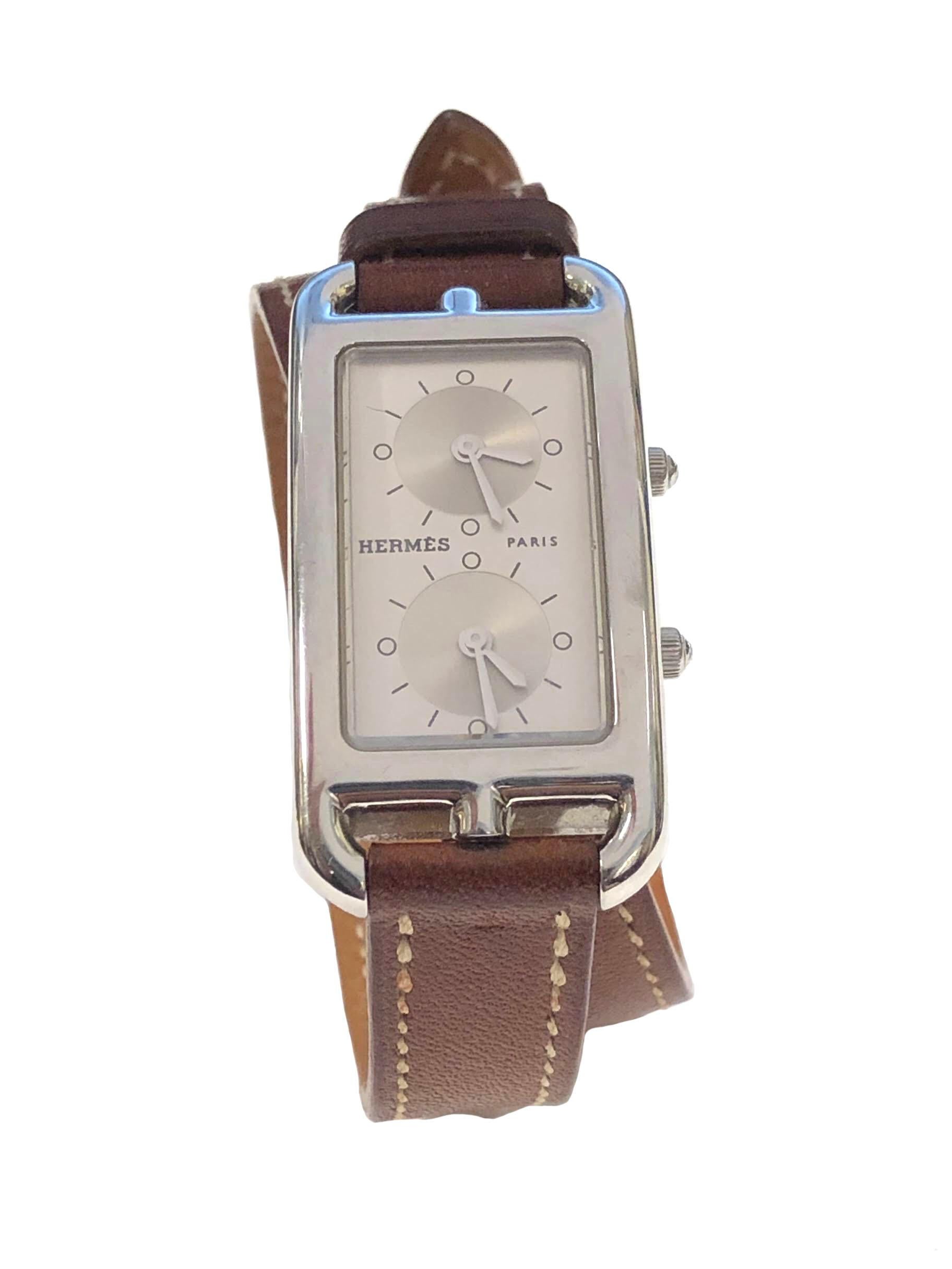 Circa 2018 Hermes Cape Cod Dual Time Zone Wrist Watch, Reference # CC3.210, 40 X 20 M.M. 2 Piece Stainless Steel case. @ independent Quartz Movements, Silver Dial. Original and near Unused Light Brown 7/16 inch wide Leather Wrap Around Strap with