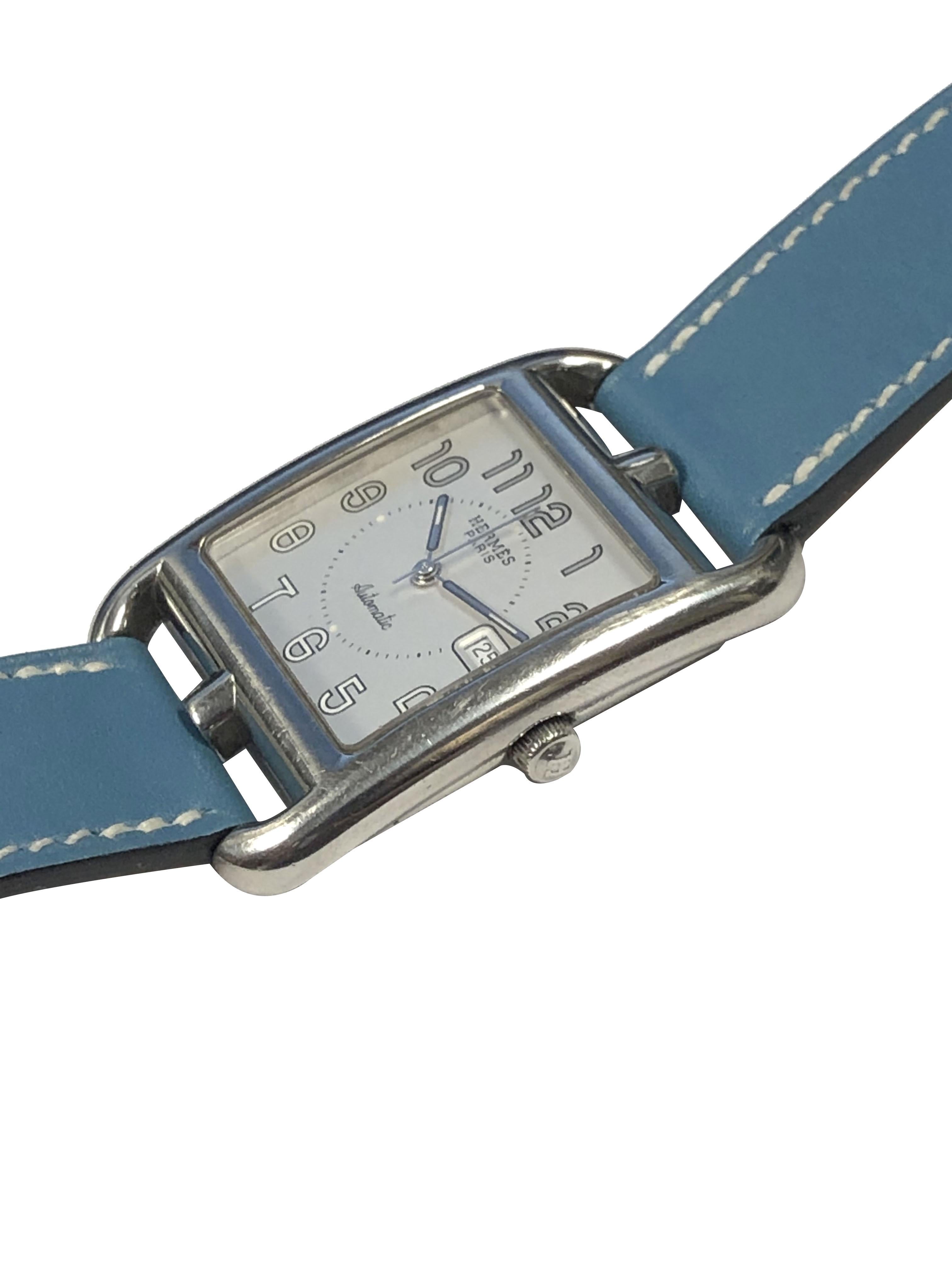 Circa 2019 Hermes Cape Cod Wrist Watch, 29 X 29 M.M. 2 Piece Water resistant case, Automatic, self winding movement, Silver Satin dial with Calendar window at the 3 position. Original Blue with White stitching wrap around 