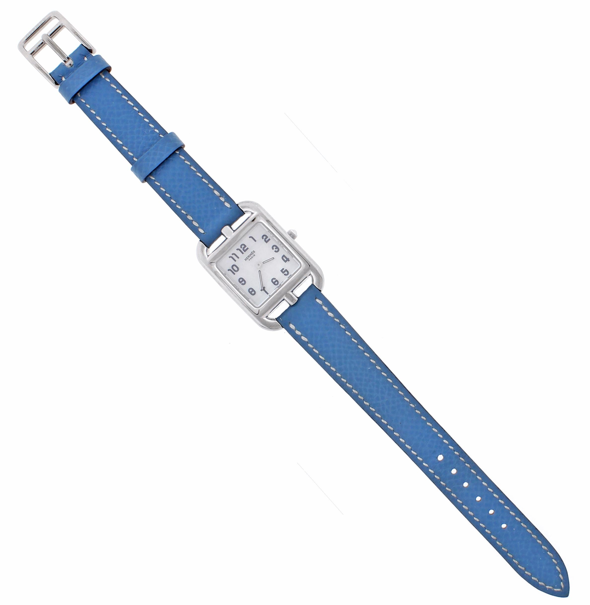 From Hermes, an elegant ladies wrist watch from their cape cod collection
♦ Designer: Hermes
♦ 18 karat  white gold square case 23mm X 23mm
♦ Blue polished leather strap with 18 karat white gold tang/pin buckle
♦ Solid screwed-in case back adorned