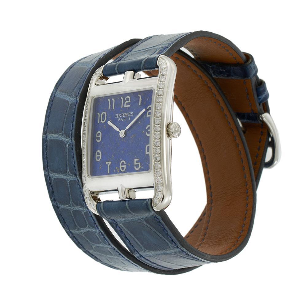 Hermès Cape Cod Ref. CC3.730 from 2017 featuring a 29 x 40MM stainless steel case with factory-set diamond bezel. The rich blue lapis dial is adorned with white Arabic numerals and signature Hermès sword-shaped hands. Paired with a 14-inch Hermès