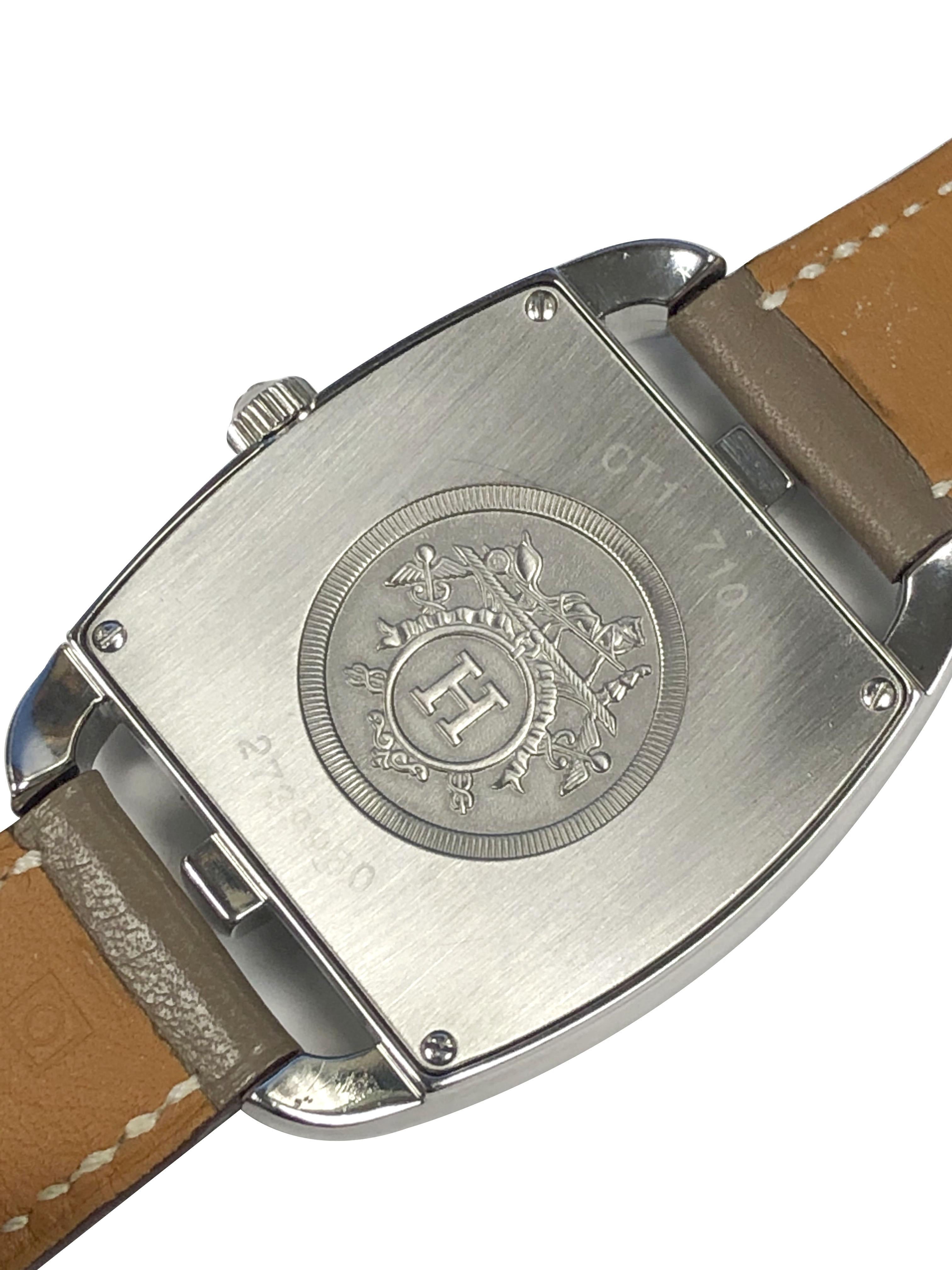 Circa 2019 Hermes Cape Cod collection Wrist Watch, 33 X 33 M.M. Stainless Steel 2 piece case, Quartz movement, White Dial with Silver Arabic numerals, sweep seconds hand and a Calendar window at the 3. Original light Gray / Taupe wrap around Strap.  